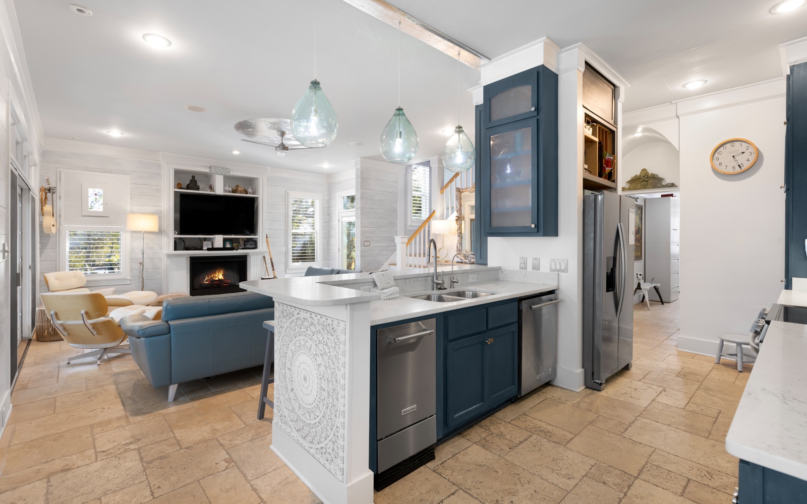 Gather in your stunning open-plan space where coastal blues meet warm whites, creating the perfect backdrop for memorable meals and relaxed evenings.