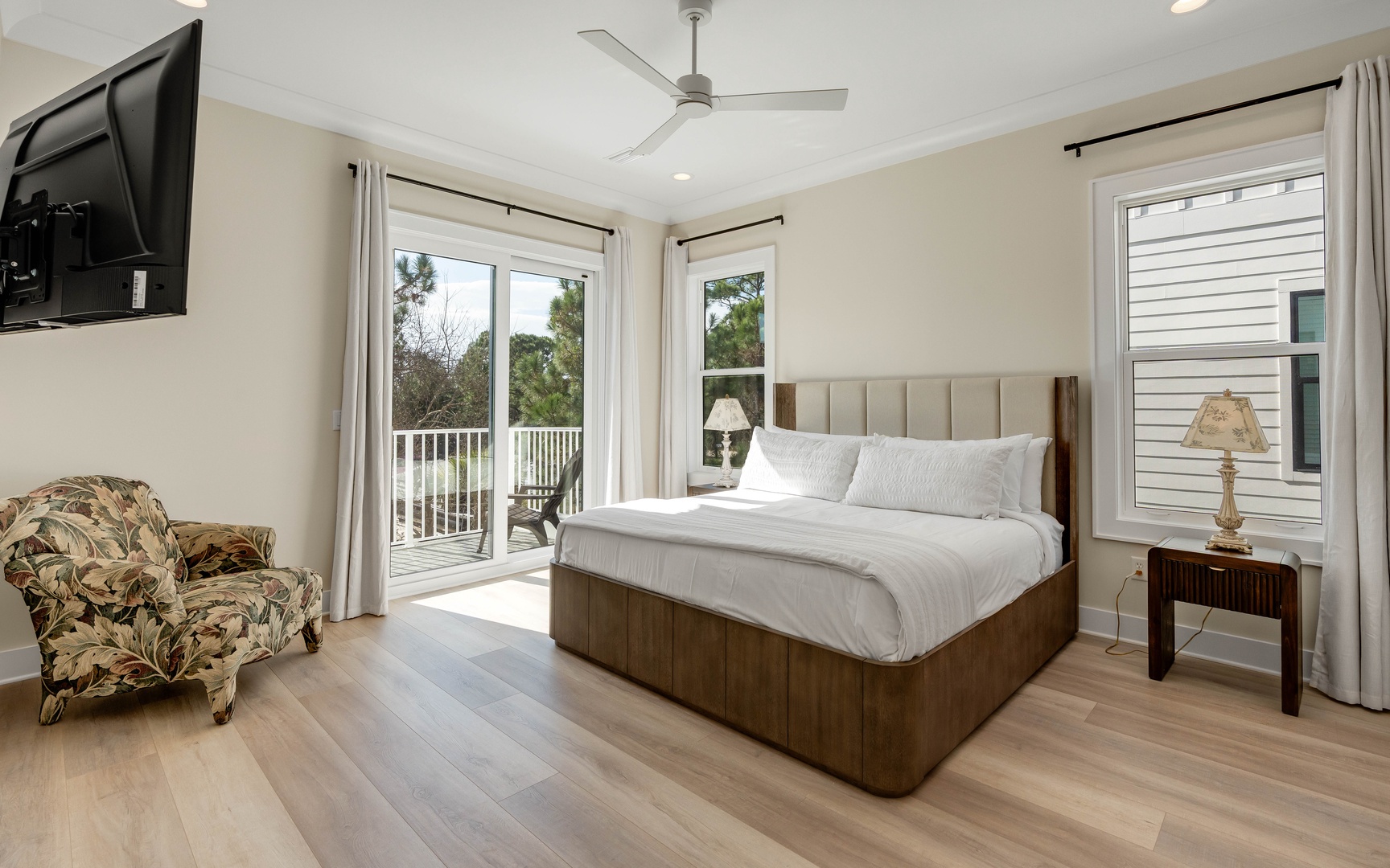 Relax in your spacious bedroom with plush bedding, private balcony access, and gentle ceiling fan keeping you comfortable throughout your stay.