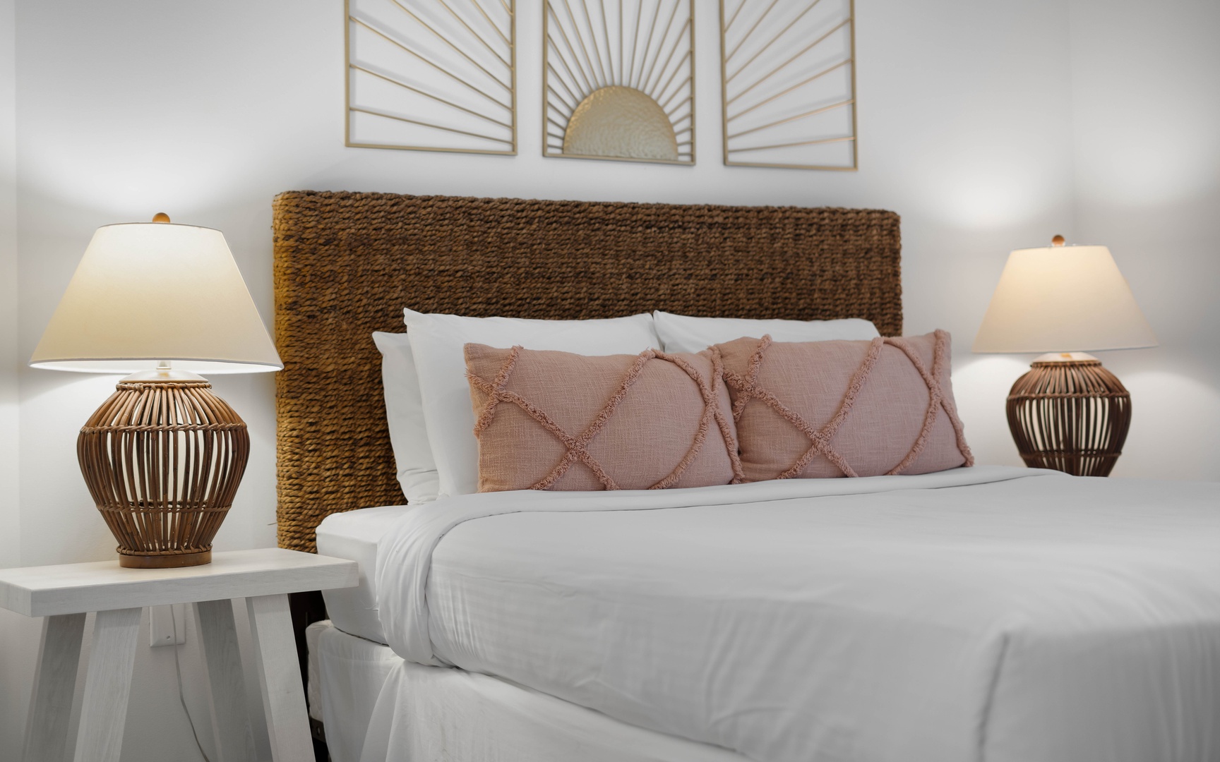 Sink into crisp white linens and soft textures in your beautifully appointed bedroom, where warm lighting creates the perfect ambiance for restful nights.