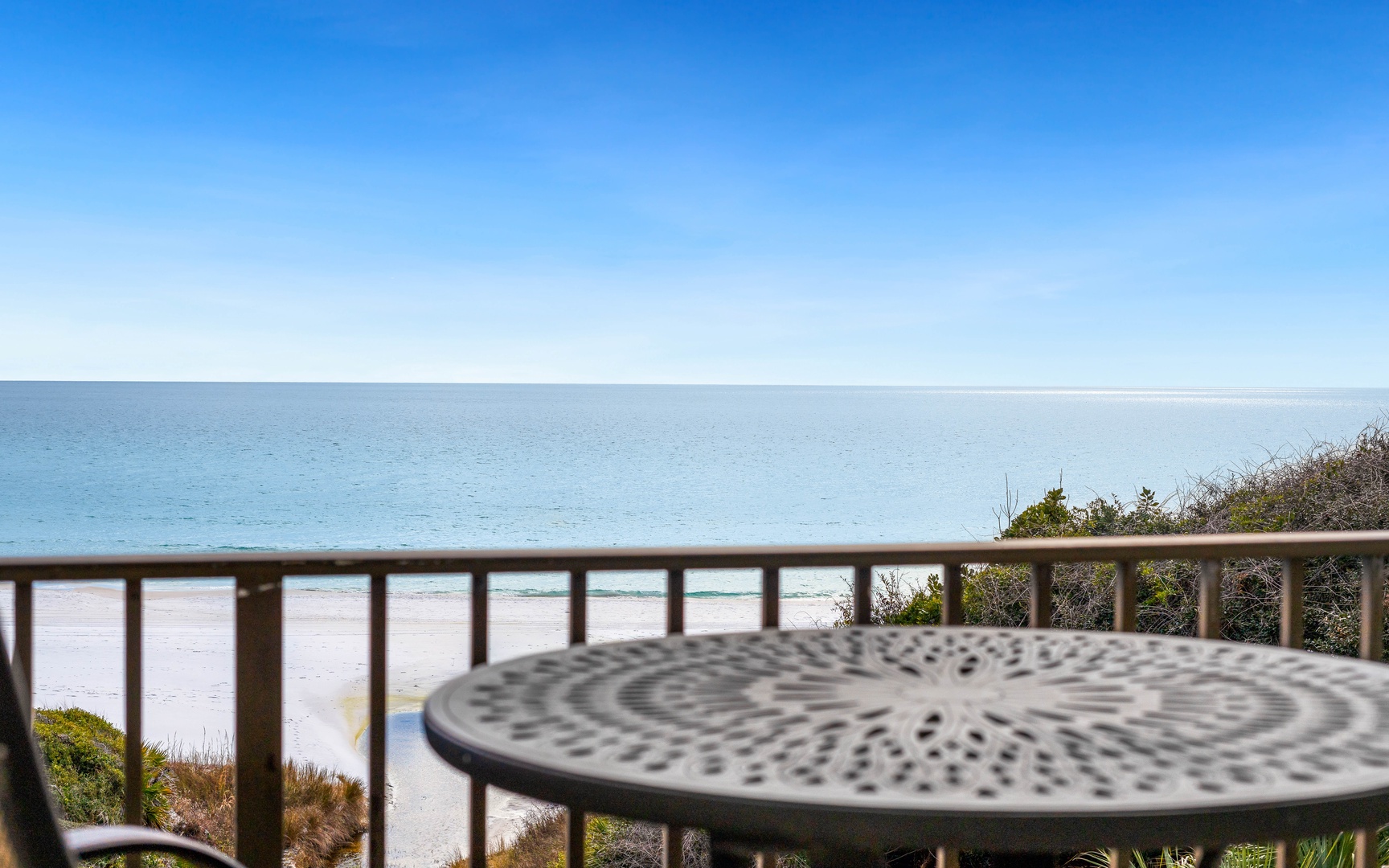 Beachfront balcony with stunning ocean views and pristine sandy shores just steps away.