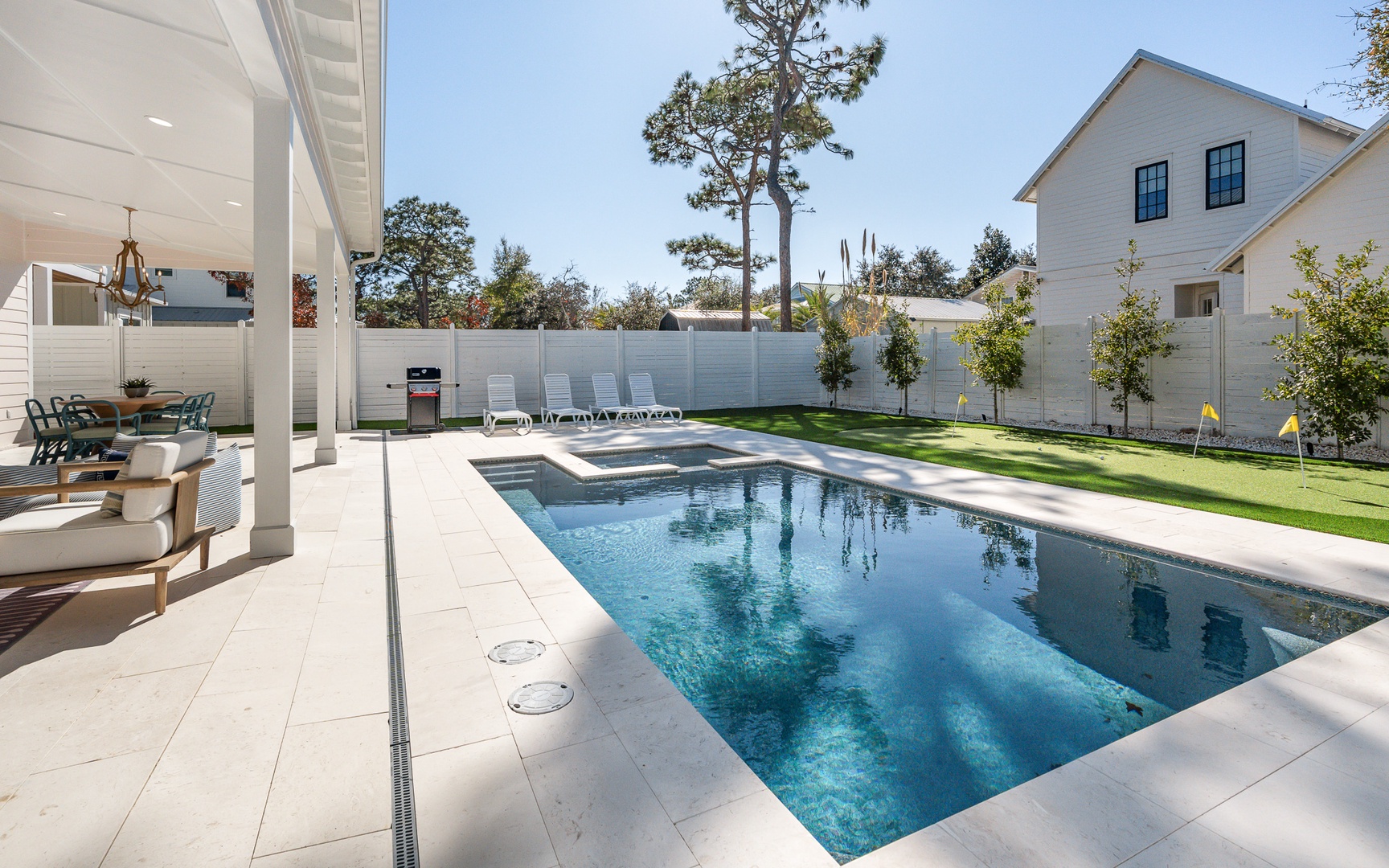 Dive into your private oasis with a stunning pool, elegant patio seating, and spa—perfect for sunny relaxation.