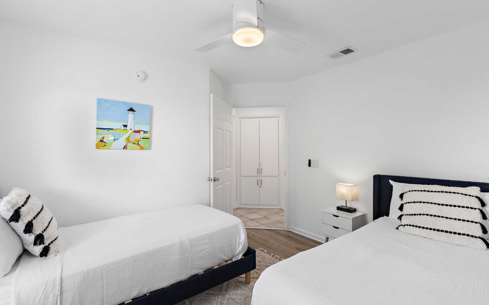 Your peaceful bedroom features two comfortable beds with crisp linens, stylish decor, and soft lighting for restful nights.