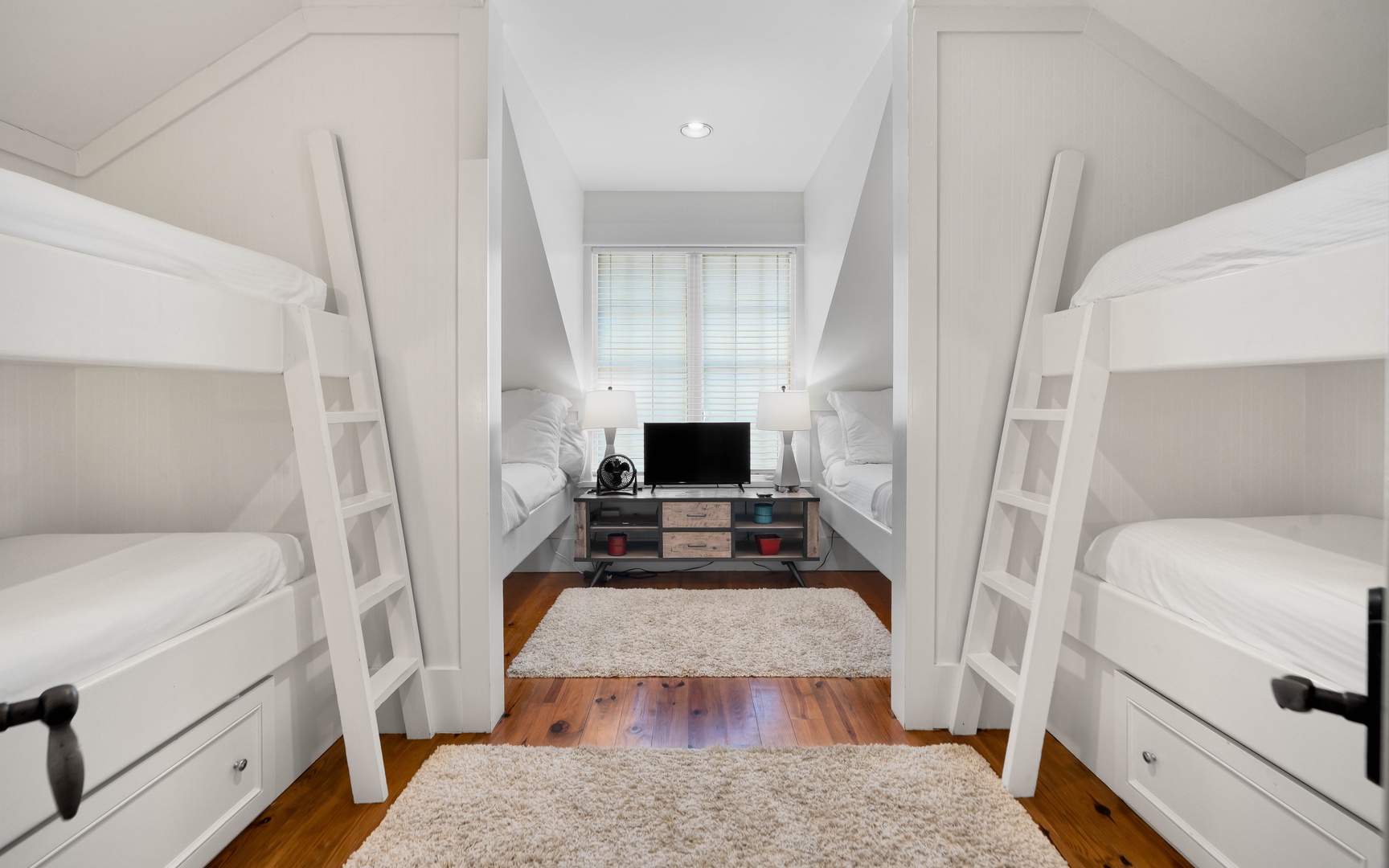 Your group will love this clever bunk room with built-in beds and cozy TV space for movie nights together.