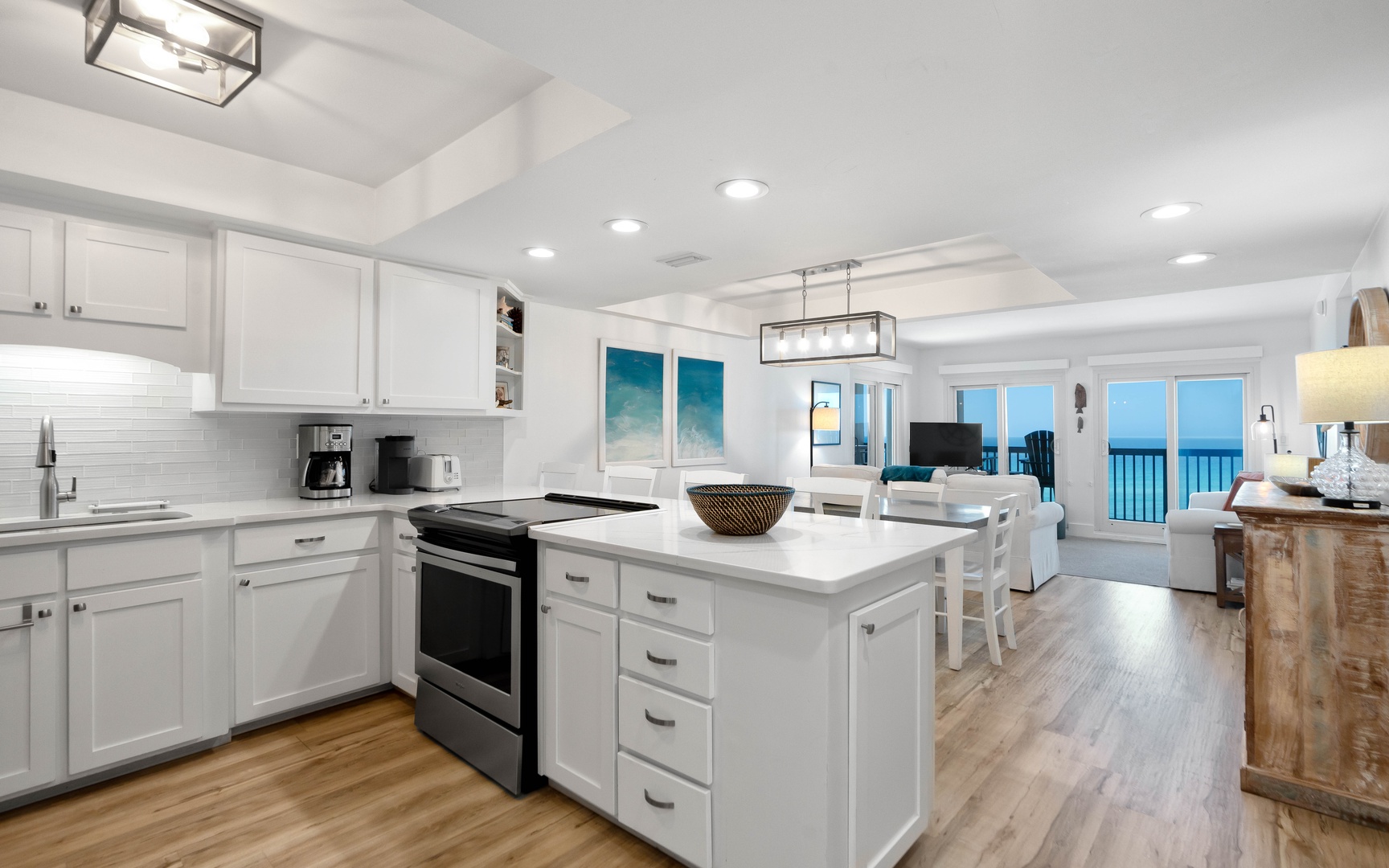 Your fully equipped kitchen flows seamlessly into the bright living area with stunning ocean views through expansive windows.