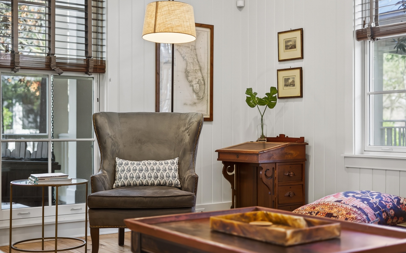 Sink into this elegant wingback chair in your bright living space, surrounded by thoughtful details and warm natural light.
