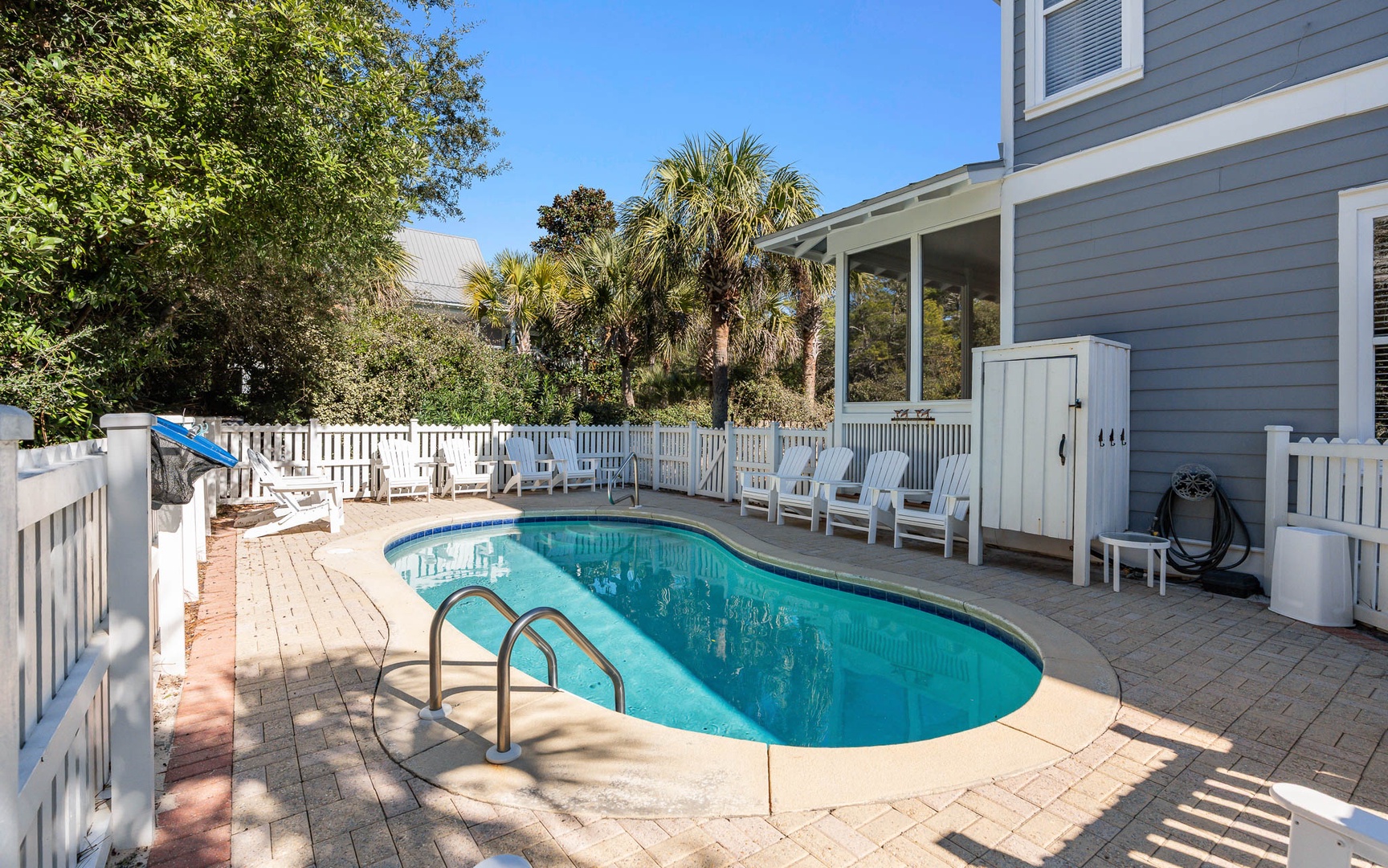 Your private oasis awaits with sparkling pool waters surrounded by tropical palms and comfortable loungers for sun-soaked relaxation.