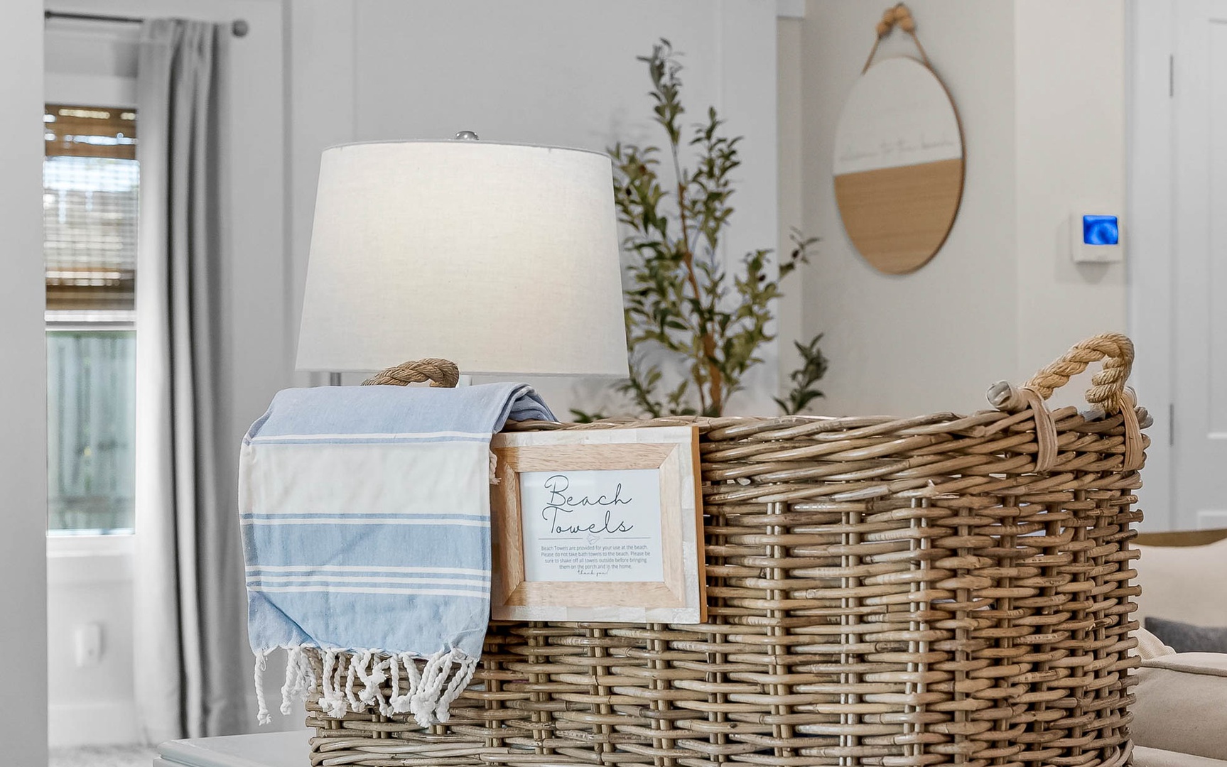 Cozy coastal touches await with soft beach towels and wicker storage baskets, creating your perfect seaside retreat.