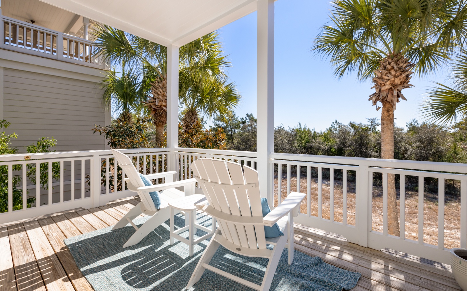 Relax in comfortable Adirondack chairs on your private covered deck, surrounded by swaying palms and peaceful natural views.