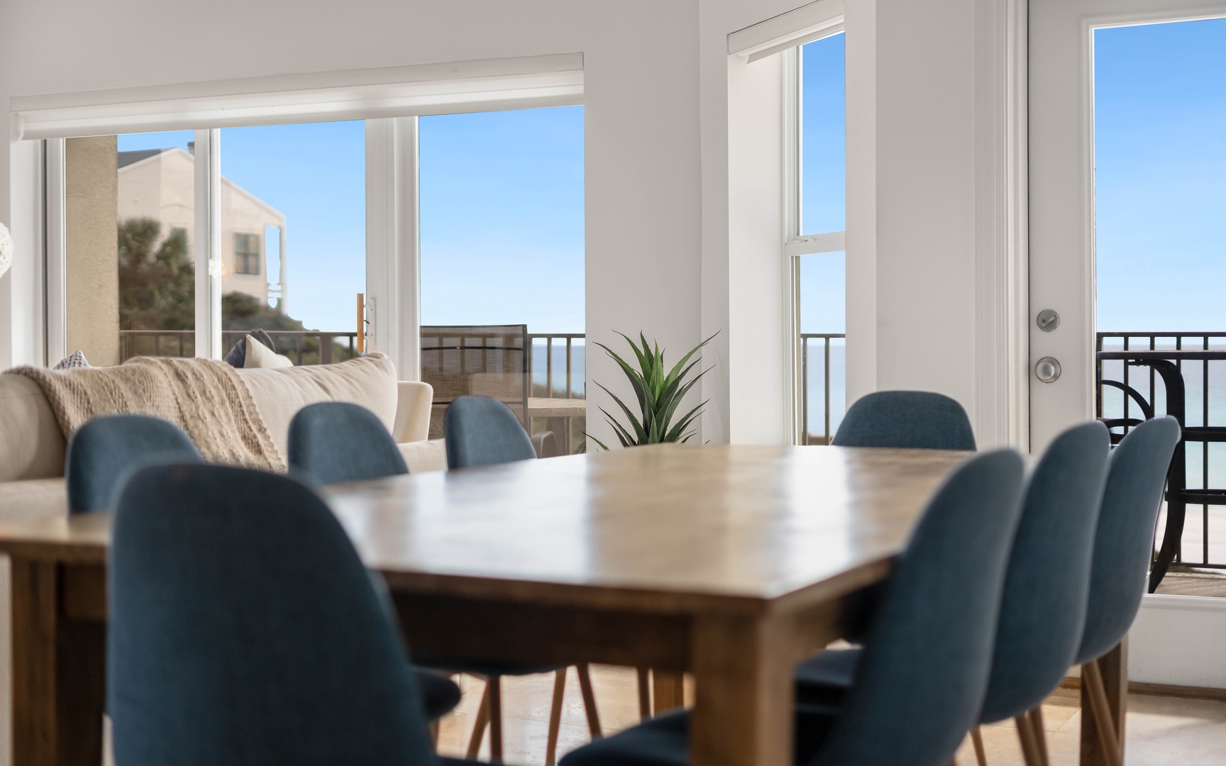 You'll love gathering around this elegant dining table with ocean views streaming through floor-to-ceiling windows.