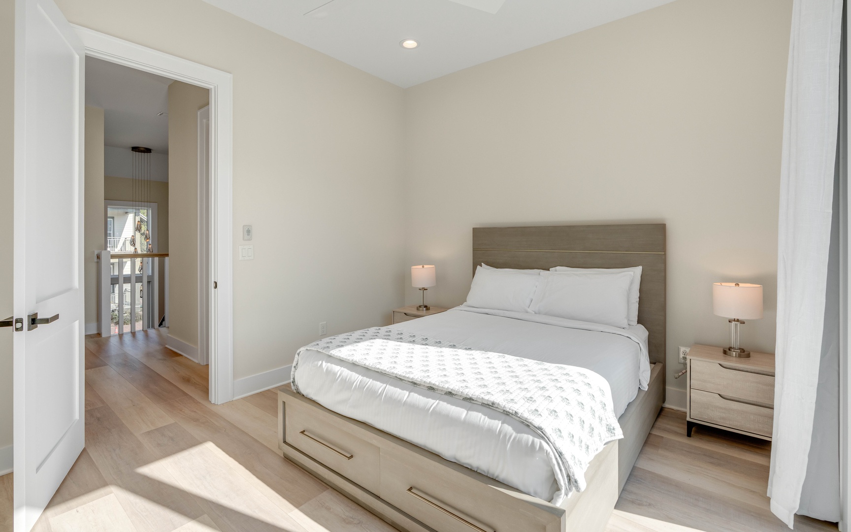 Your serene bedroom sanctuary awaits with crisp linens, warm bedside lighting, and contemporary comfort for the perfect night's rest.