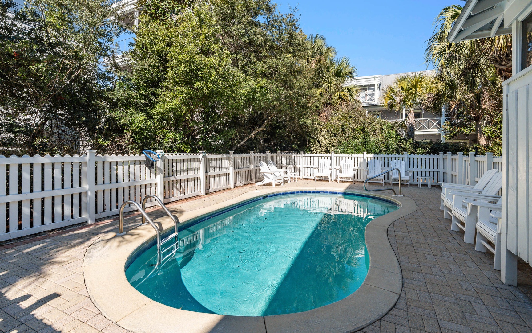 Dive into your private oasis where sparkling turquoise waters invite relaxation beneath swaying palms and sunny skies.