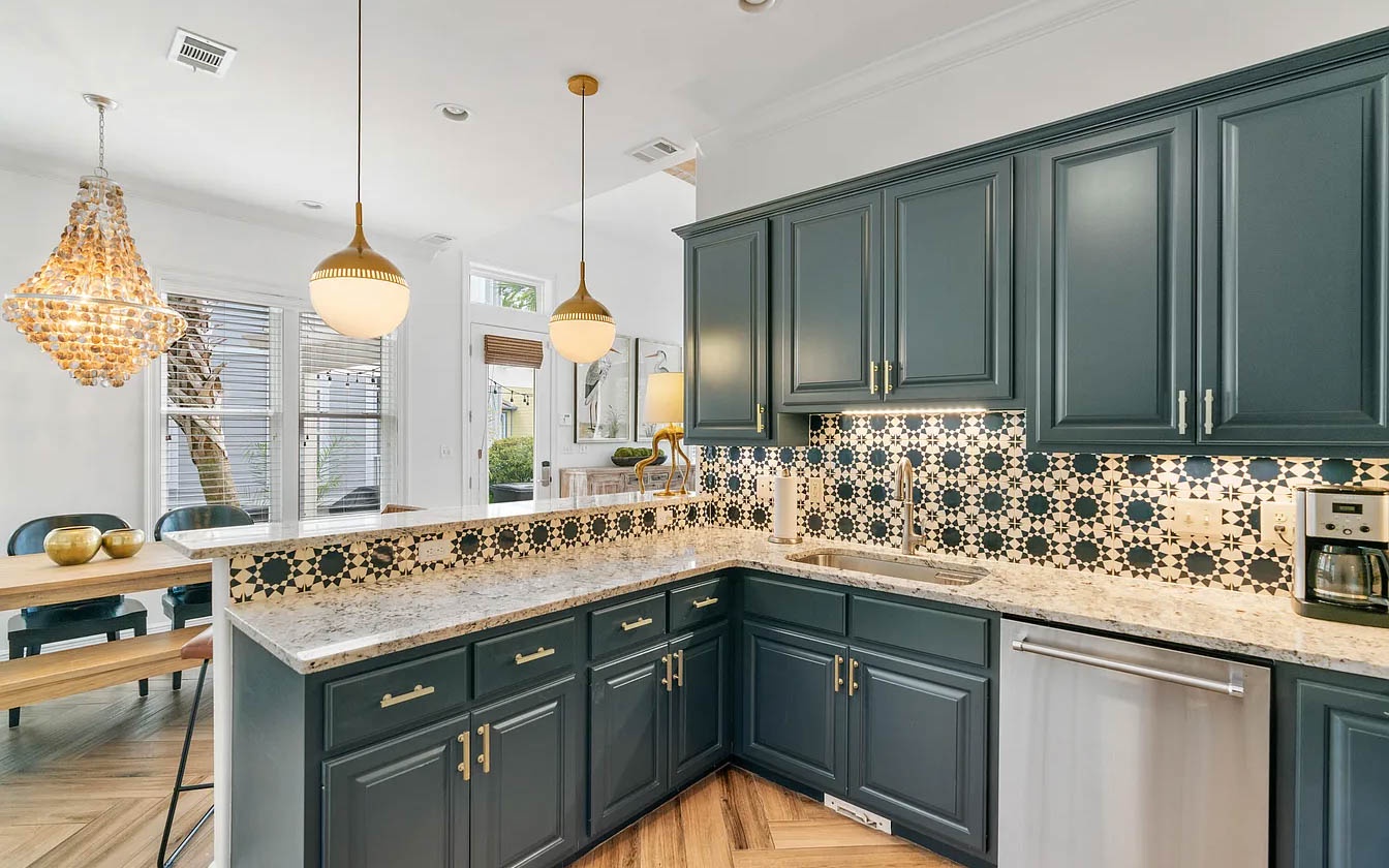 Your spacious kitchen awaits with elegant green cabinets, granite counters, and distinctive patterned backsplash for memorable meal preparation.
