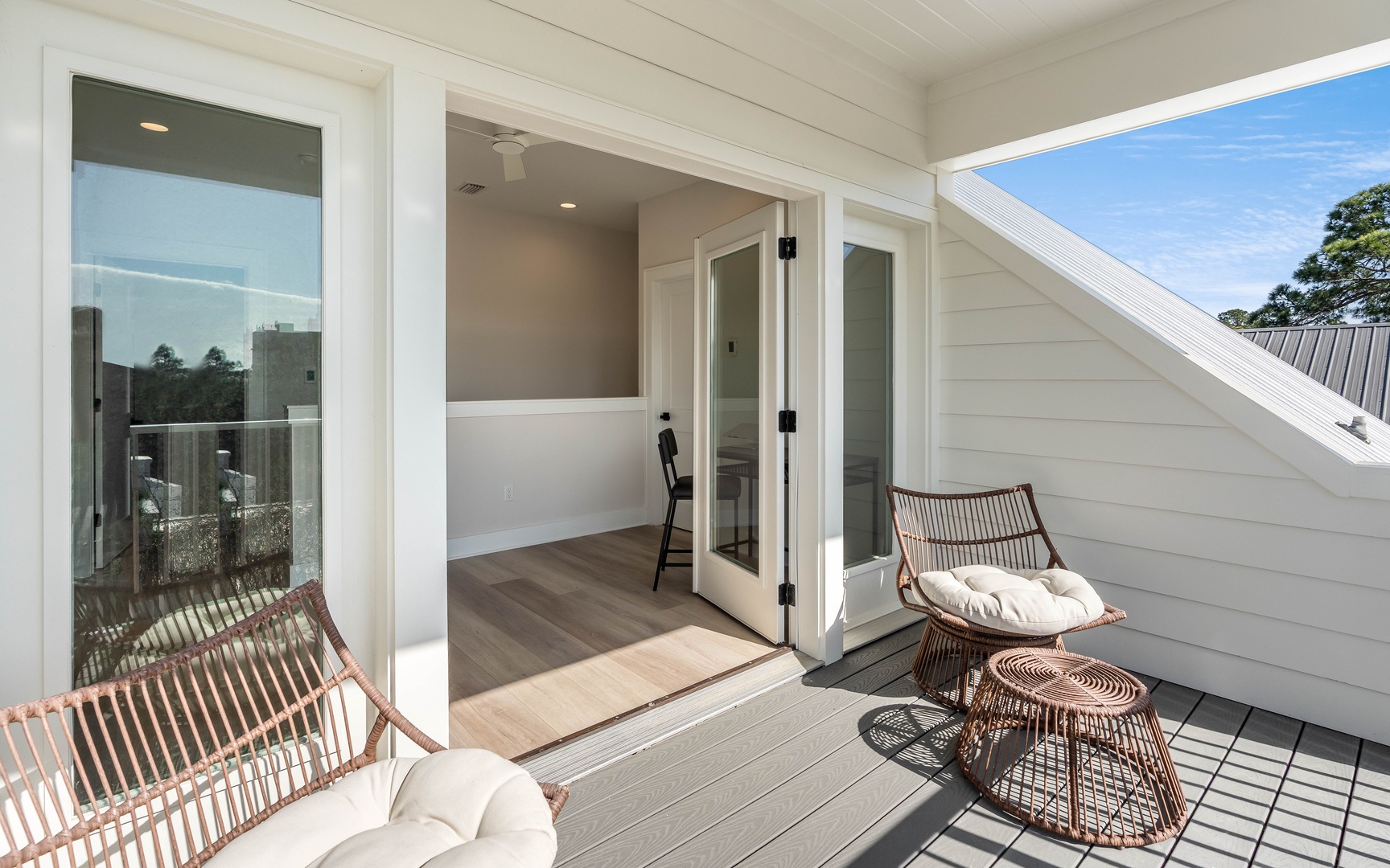 Unwind in your private terrace sanctuary with stylish wicker seating and seamless indoor-outdoor flow through French doors.