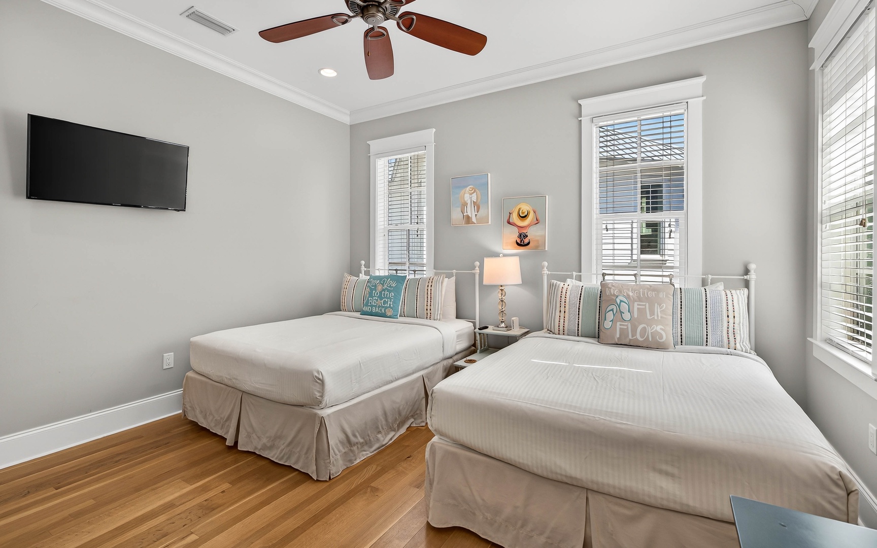 Your peaceful twin bedroom offers comfortable beds, ceiling fan, and natural light for a restful stay.
