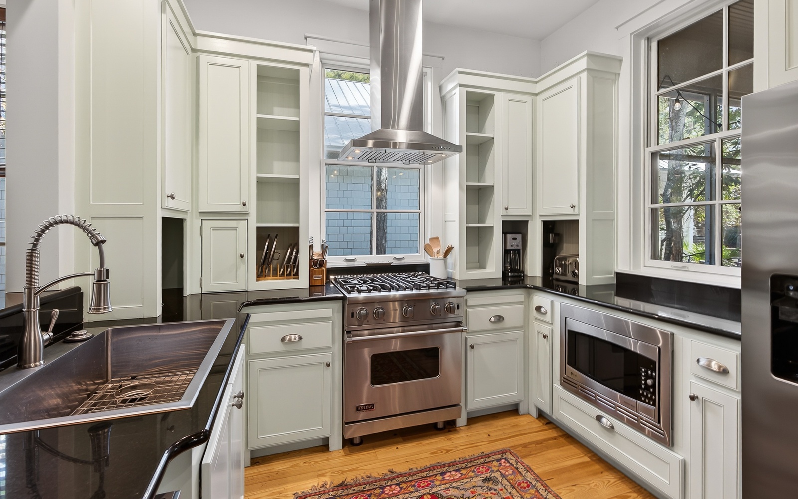 Your culinary dreams come alive in this stunning gourmet kitchen with professional appliances and elegant white cabinetry.