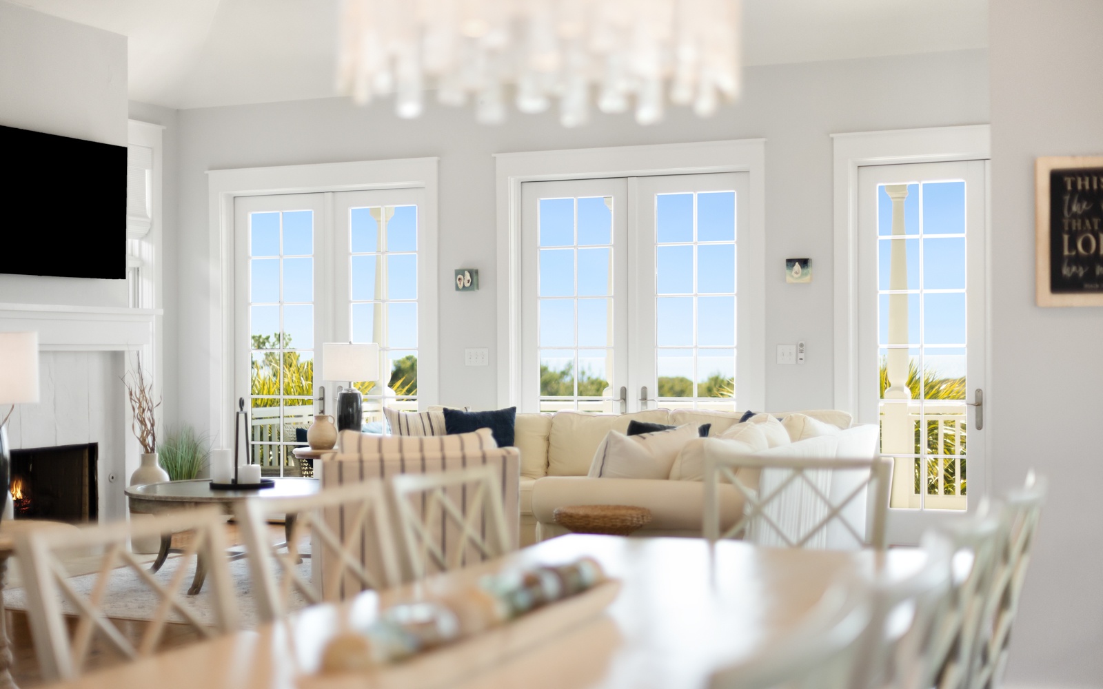 Sink into the plush sectional while natural light floods through French doors, creating your perfect spot to unwind with fireplace warmth nearby.