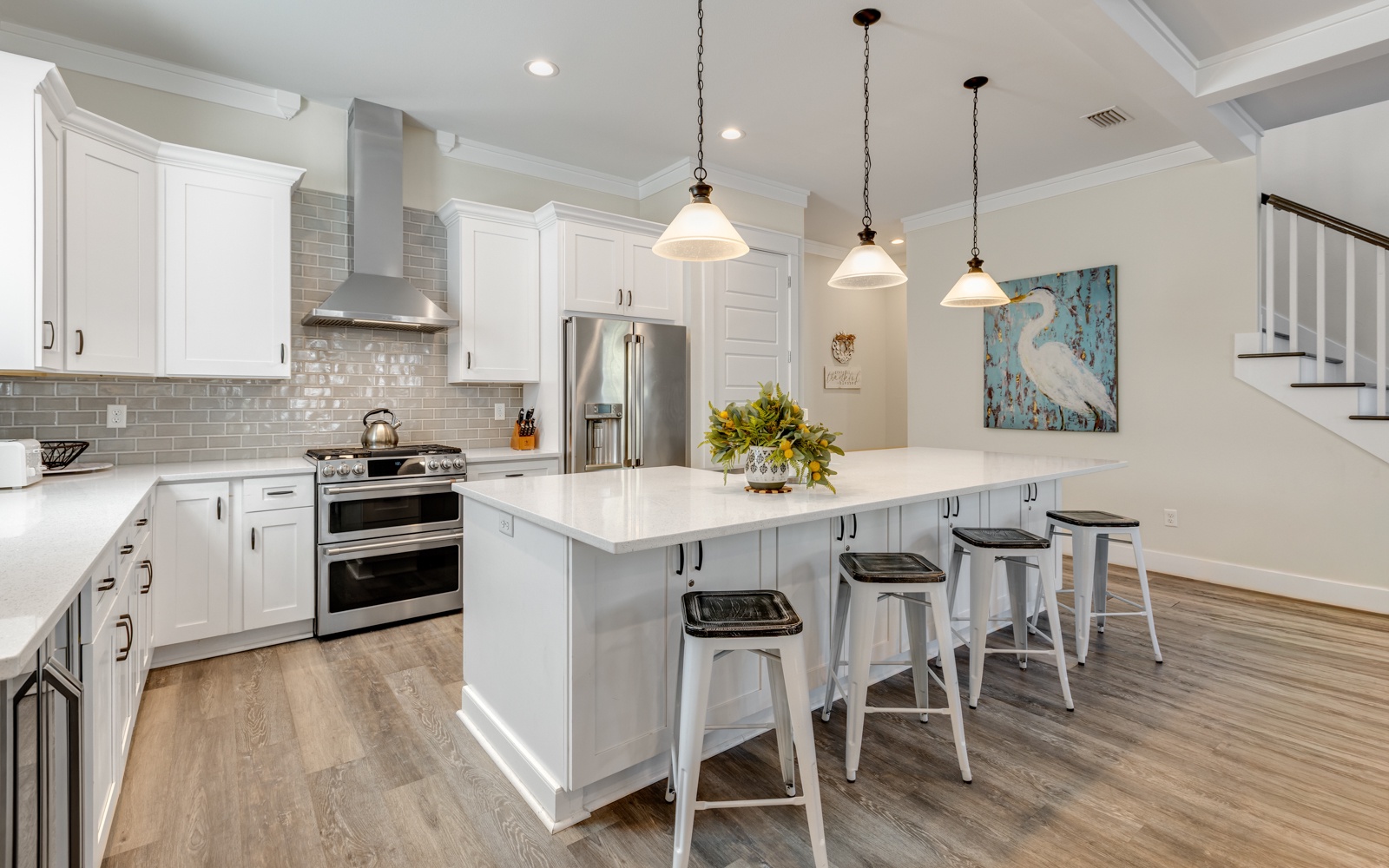 Your gourmet kitchen awaits with gleaming counters, modern appliances, and stylish island seating for memorable meal prep and casual dining together.