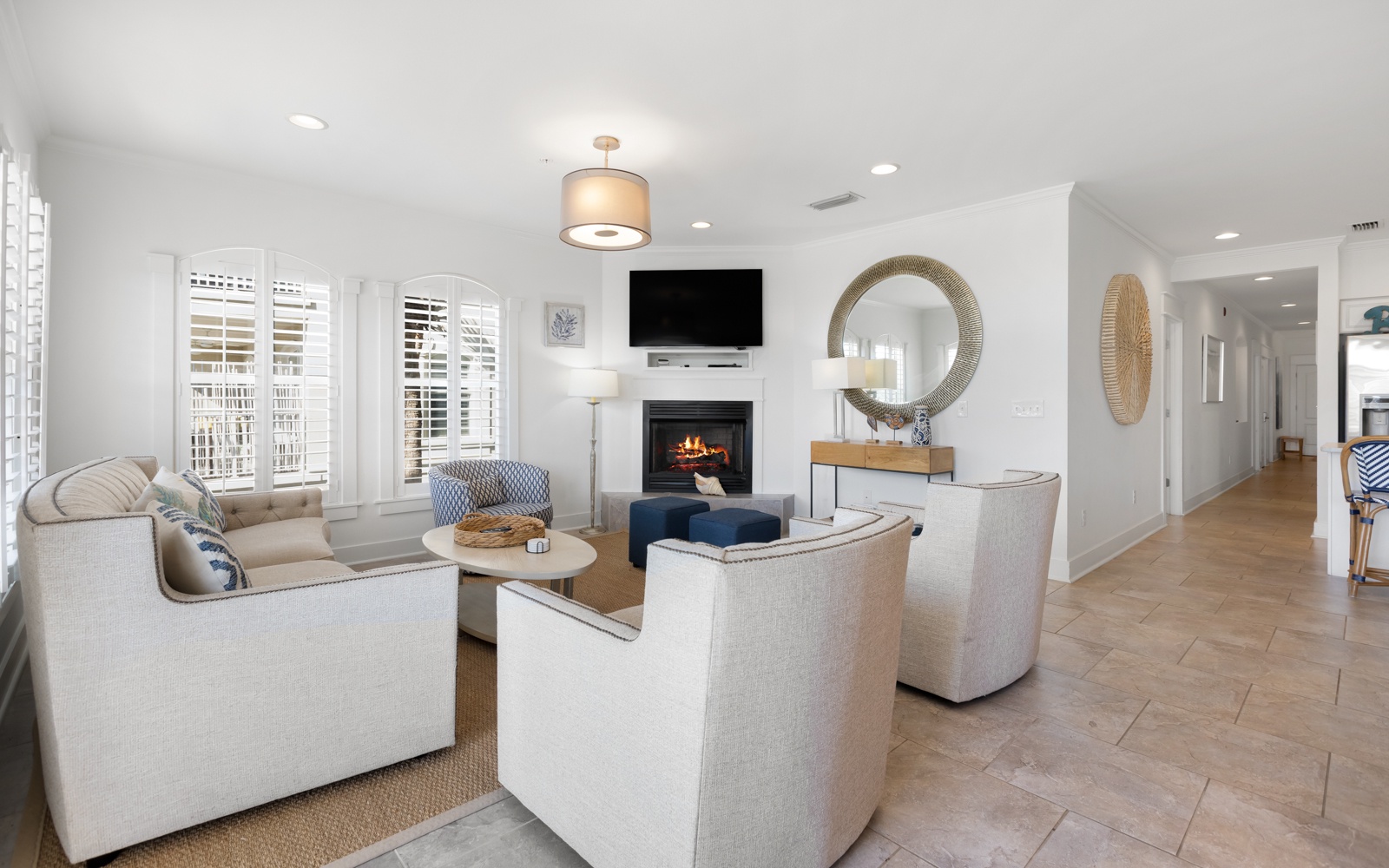 Sink into plush seating around the crackling fireplace while your favorite shows play on the mounted TV—pure comfort awaits.