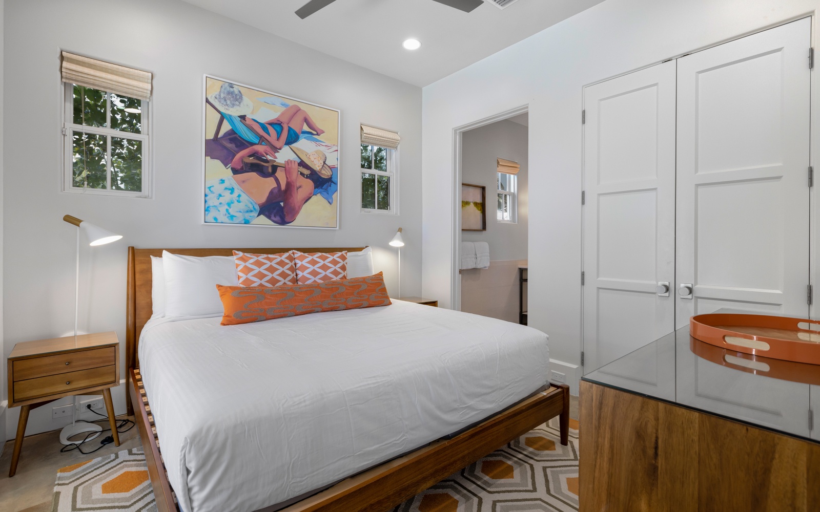 Drift into peaceful sleep in this bright, artfully designed bedroom with crisp linens and modern touches.