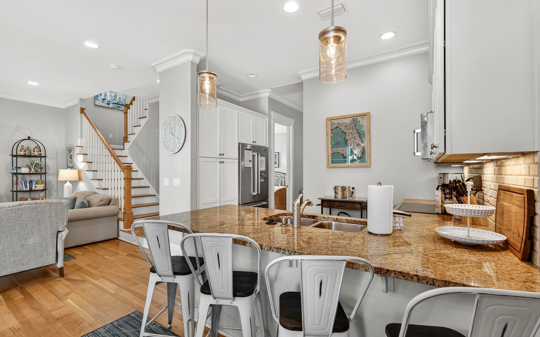 Gather around this stunning granite island where memories are made over morning coffee and evening conversations in your open-concept haven.