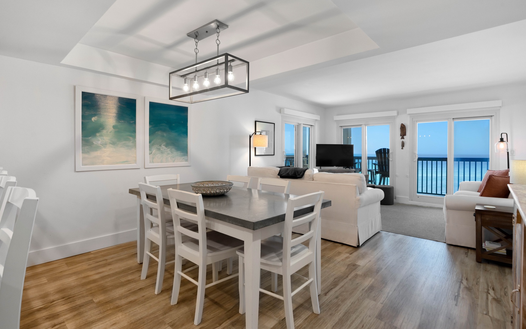 Unwind in this bright beachfront space where coastal art meets modern comfort, with ocean views framing your dining and relaxation.