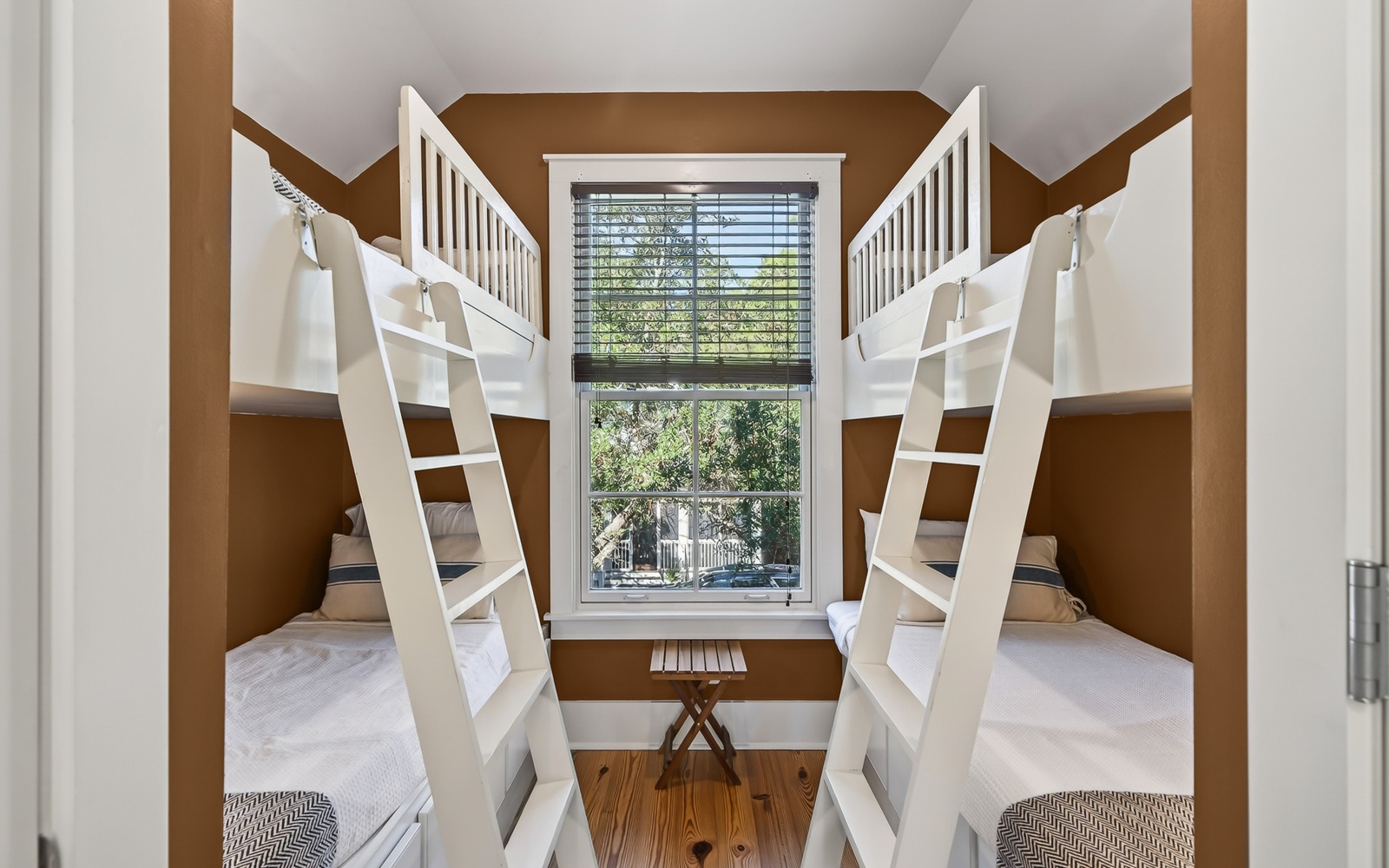 Rest in your cozy bunk room where modern comfort meets playful design, complete with crisp linens and peaceful garden views.