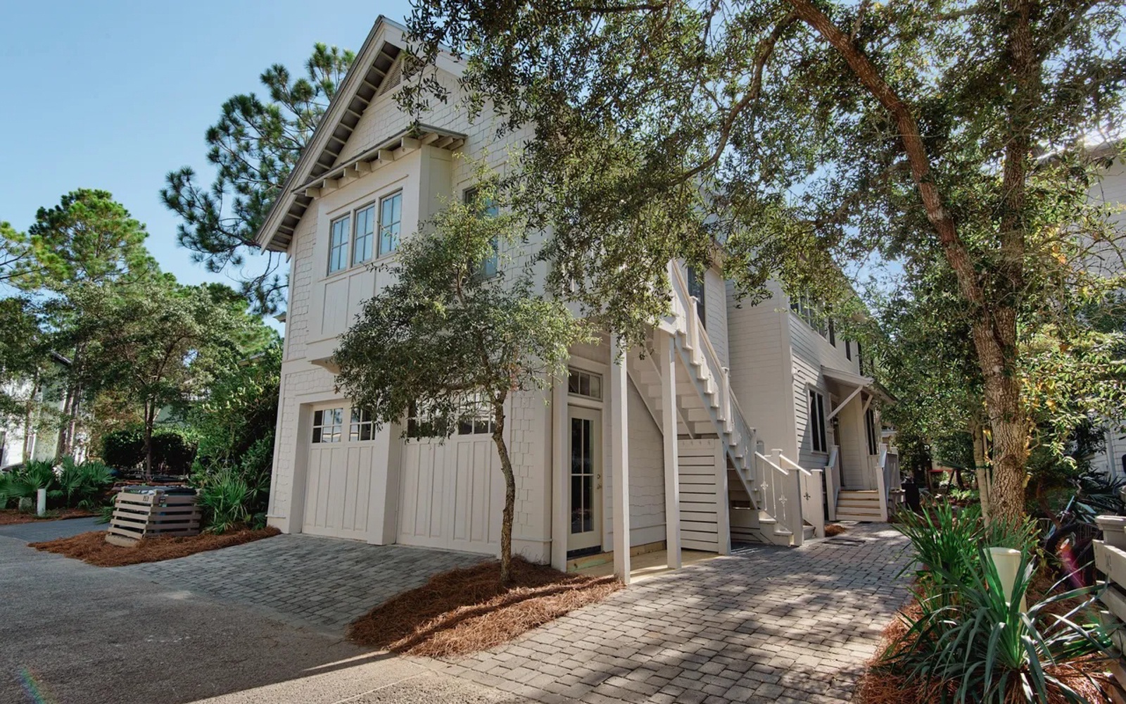 Elegant coastal retreat with charming architecture nestled among mature trees and landscaped grounds.