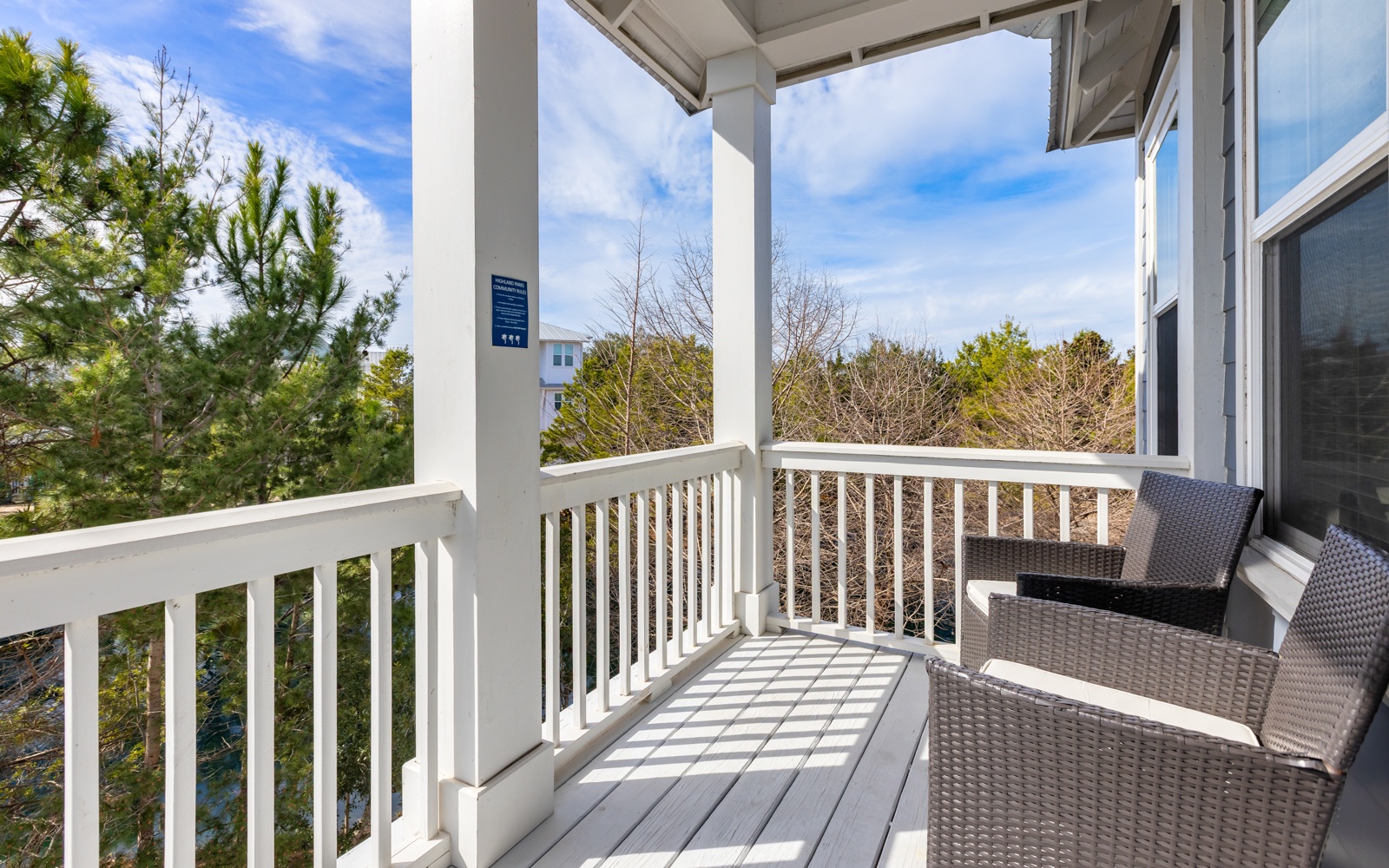 Unwind on your private covered balcony with comfortable seating and treetop views—perfect for morning coffee or peaceful evenings.