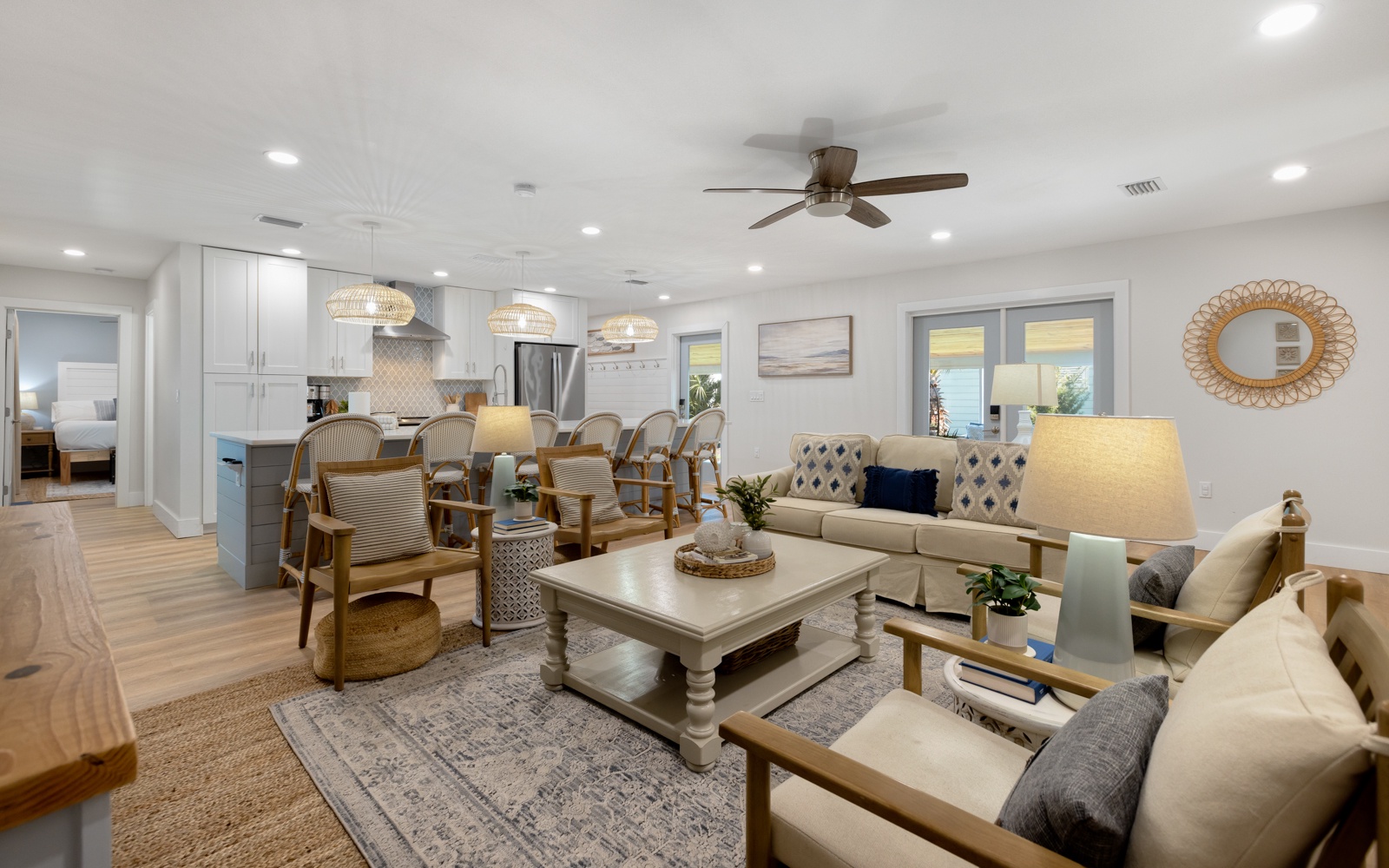 Relax in your spacious open-plan living area with coastal-inspired decor, modern kitchen, and comfortable seating perfect for gathering with loved ones.