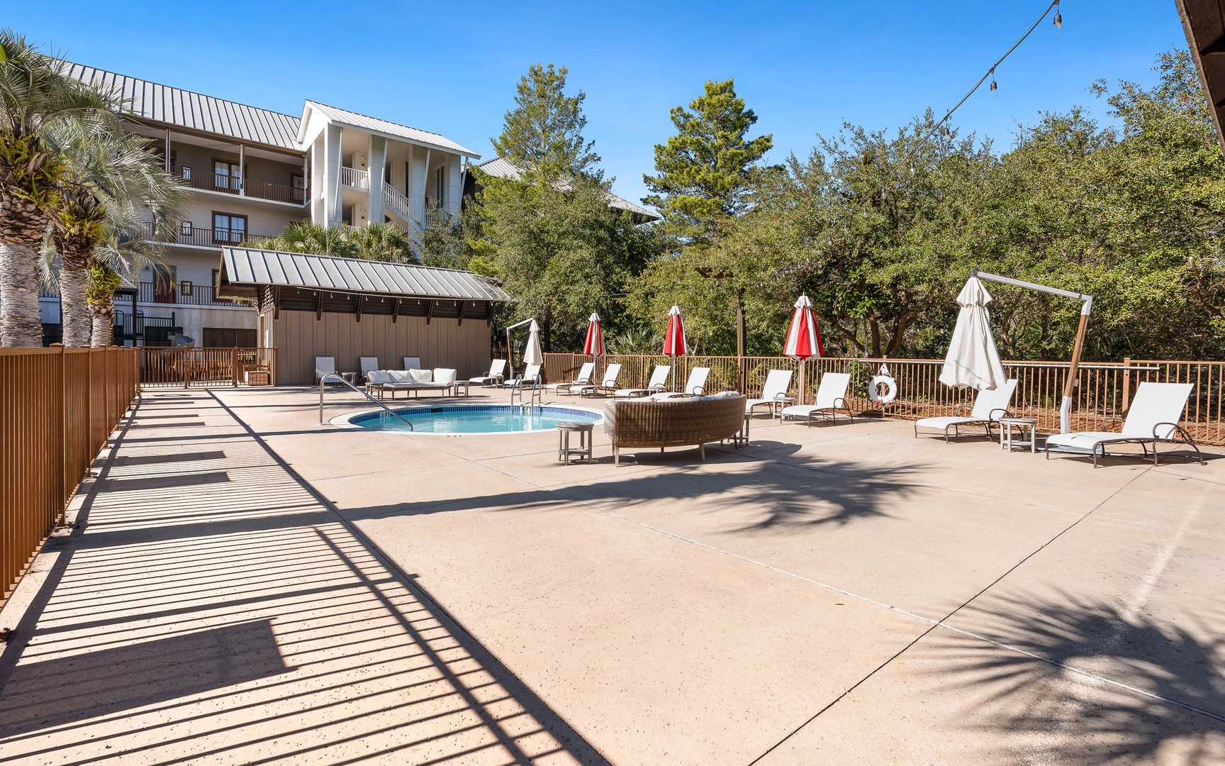 Soak up the sun by your private pool, surrounded by lush greenery and comfortable loungers for the perfect relaxation retreat.