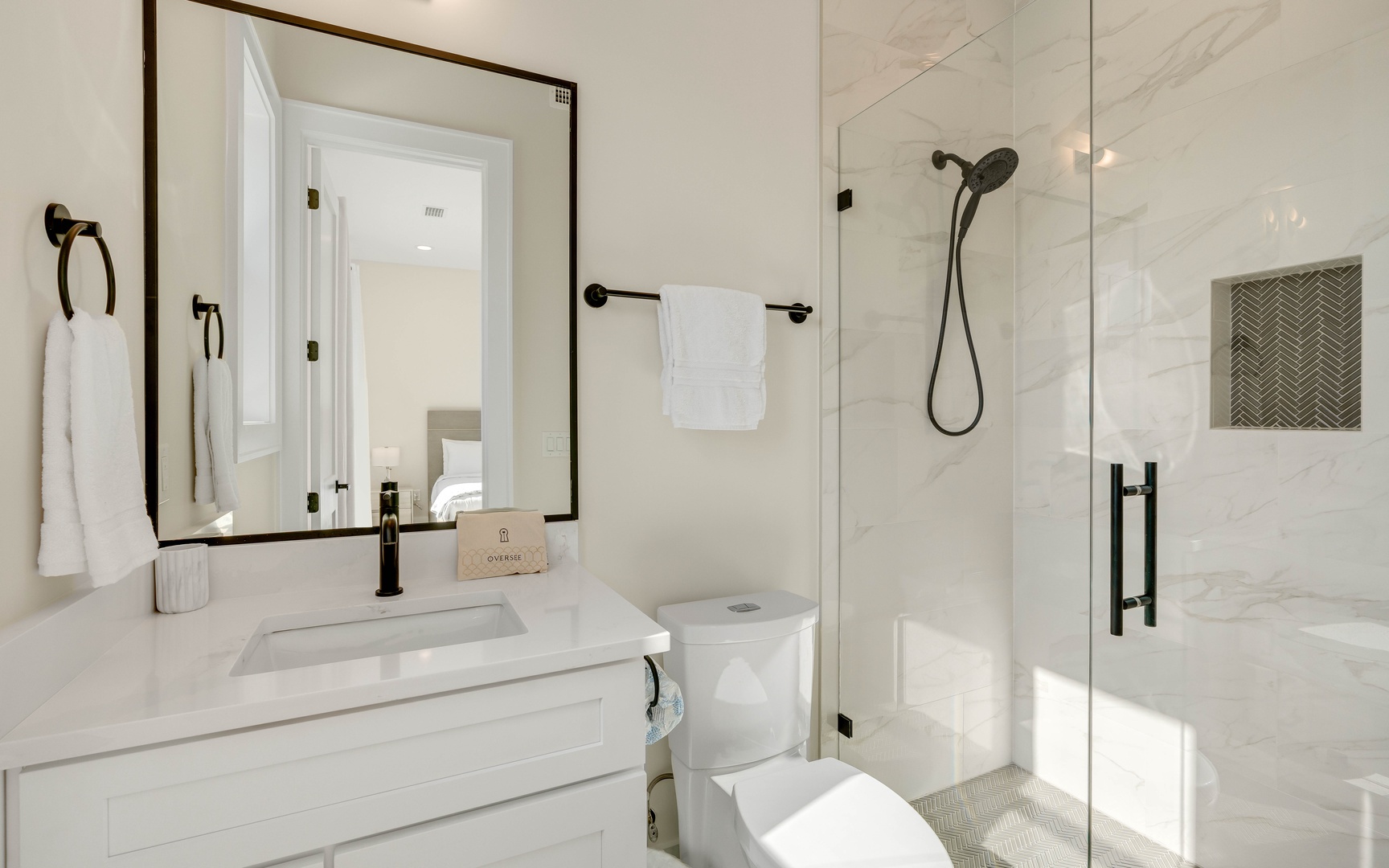 Step into your sleek marble bathroom featuring a spacious walk-in shower and elegant black fixtures for a luxurious retreat.