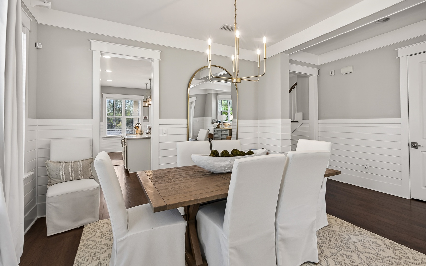 Step into your elegant dining space where warm wood meets crisp white details, perfect for memorable meals together.