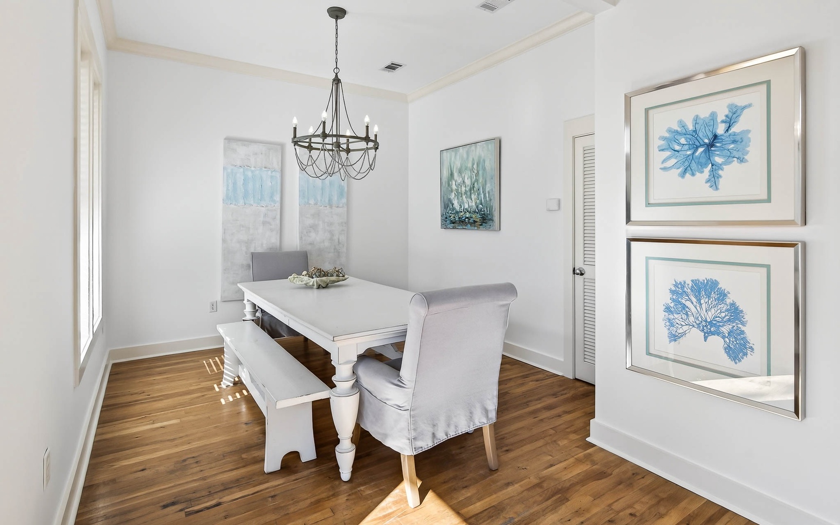 Your elegant dining space features coastal artwork and natural light, perfect for memorable meals with loved ones.