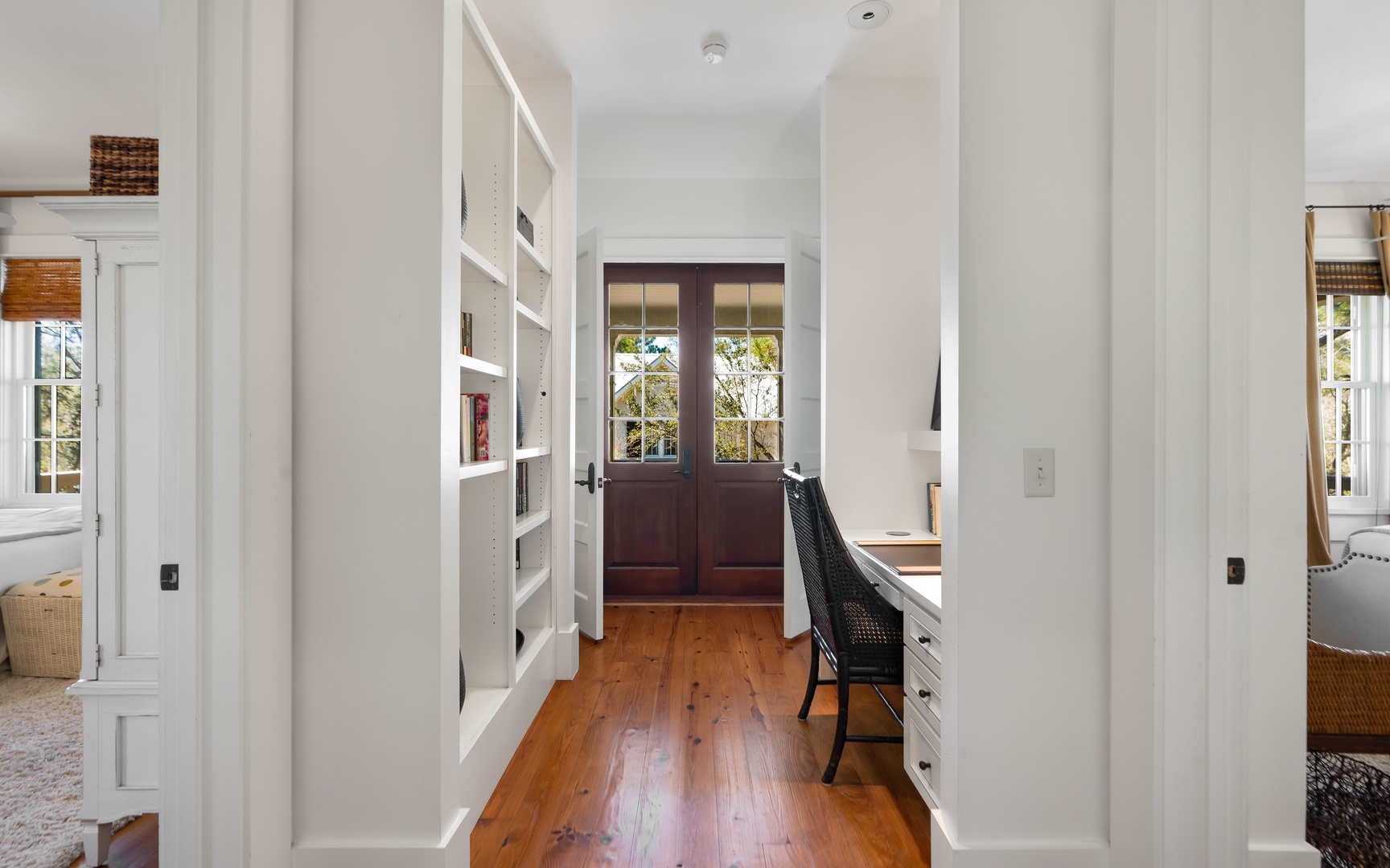 Your private study nook features built-in shelving, warm wood floors, and French doors opening to garden views—perfect for quiet work.