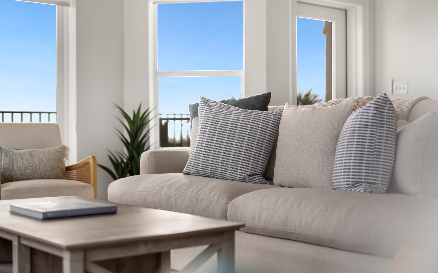 Sink into plush seating while bright ocean views fill your living space through floor-to-ceiling windows.