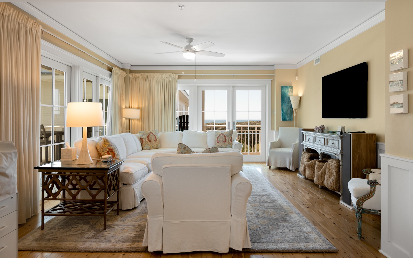 Settle into this elegant living room where plush white seating surrounds a chic coffee table, perfect for your morning coffee or evening conversations.