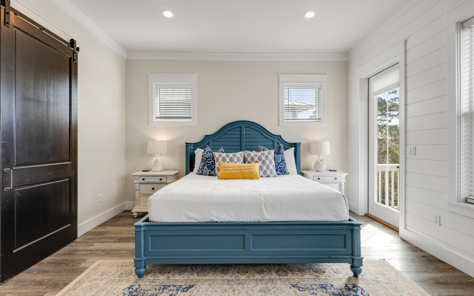 Sink into the plush comfort of your coastal-inspired bedroom, where crisp linens and charming teal accents create your perfect retreat.