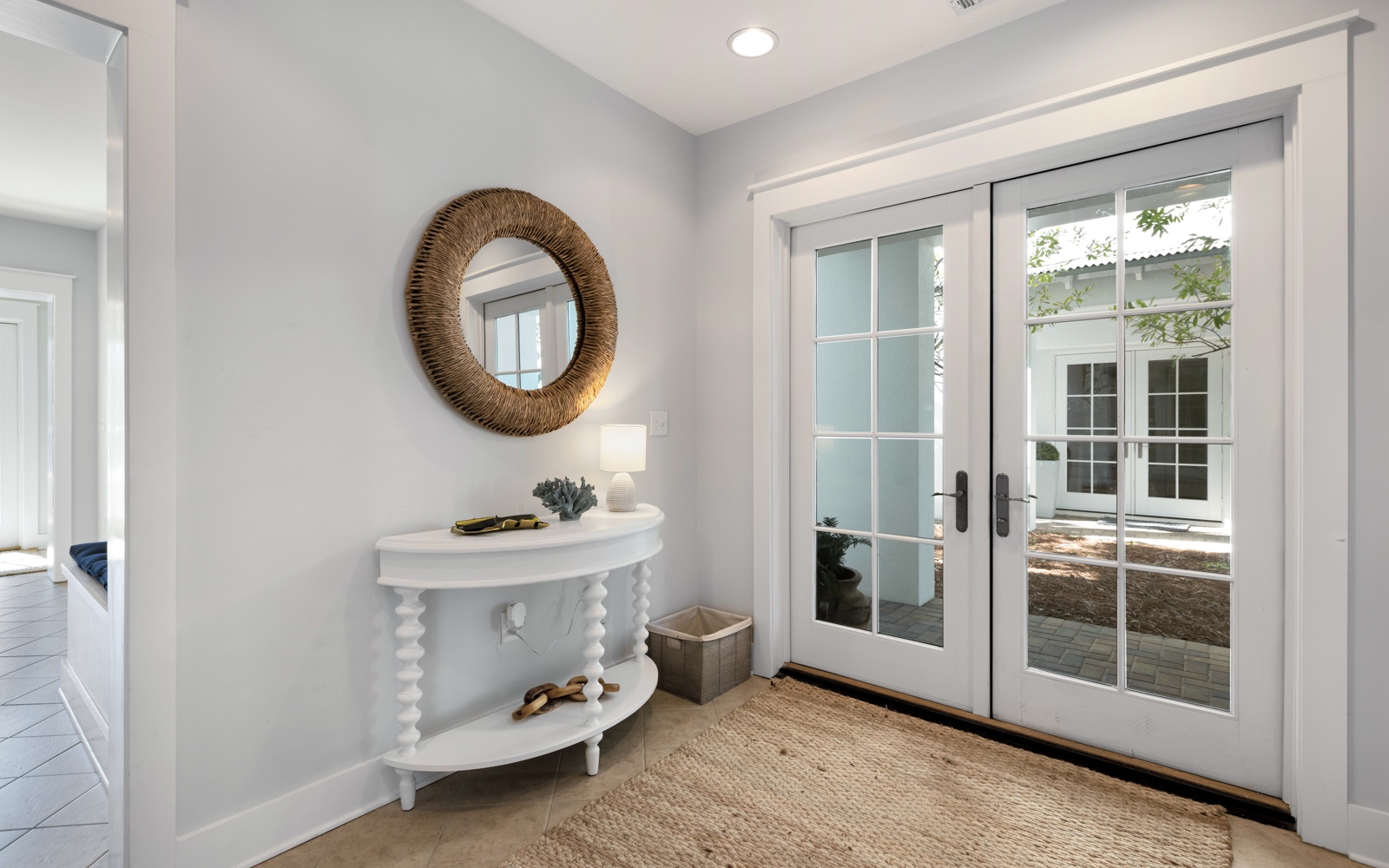 Step into your bright, welcoming entrance where coastal charm meets modern elegance, setting the tone for your perfect getaway.