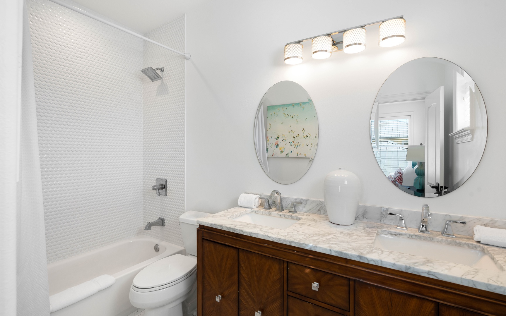 Your spa-like bathroom features a deep soaking tub, marble double vanity, and elegant pendant lighting for your morning routine.