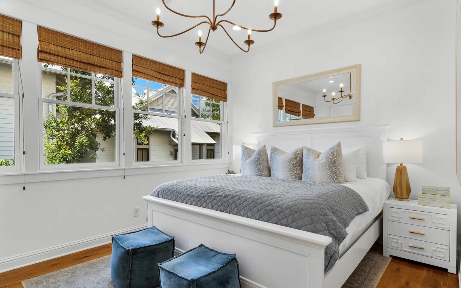 Slip into crisp white linens and cozy gray throws in your bright bedroom, where morning light filters through bamboo shades.