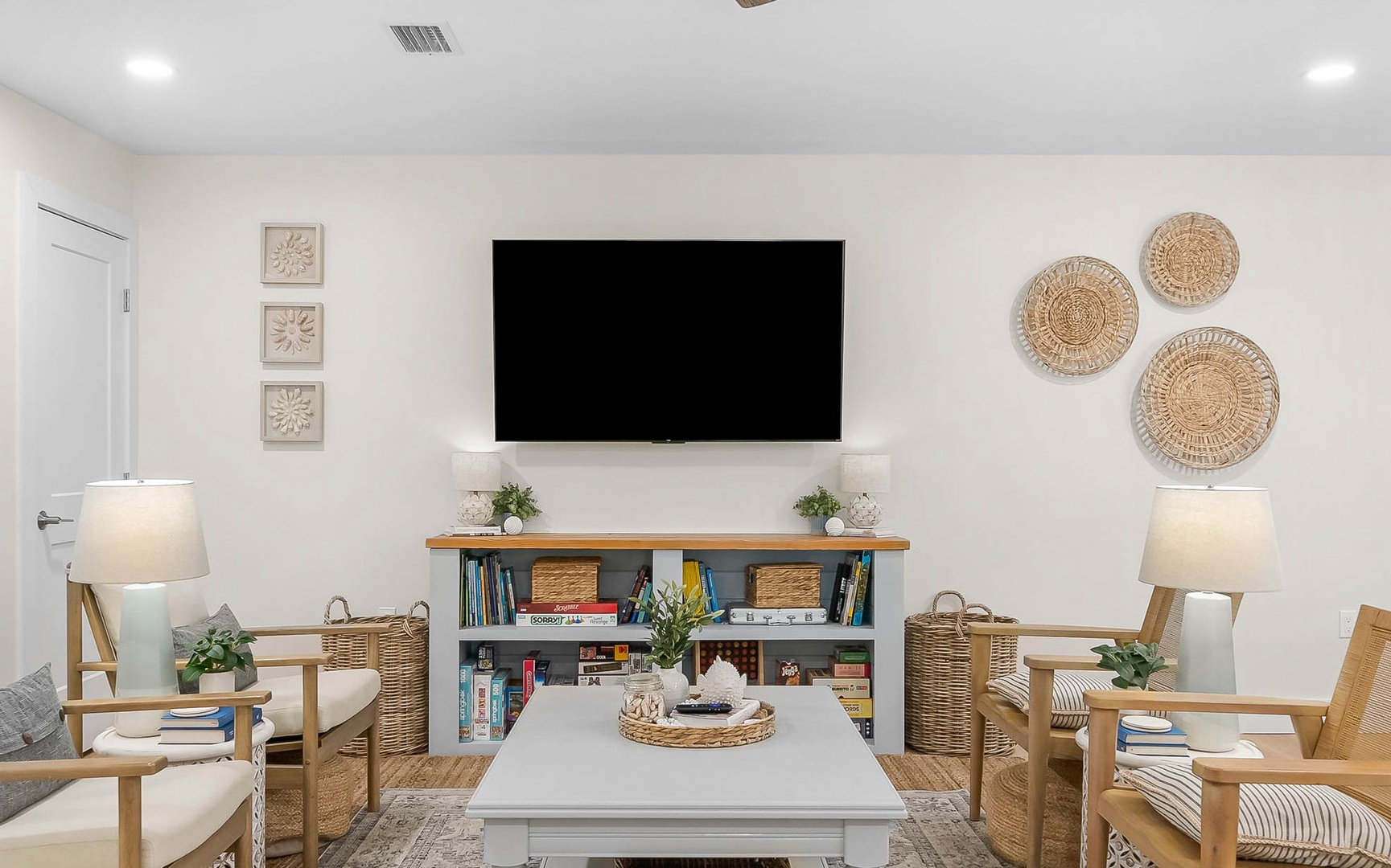 Relax in your bright living space with comfy seating, entertainment center, and coastal-inspired decor that creates the perfect atmosphere for unwinding.