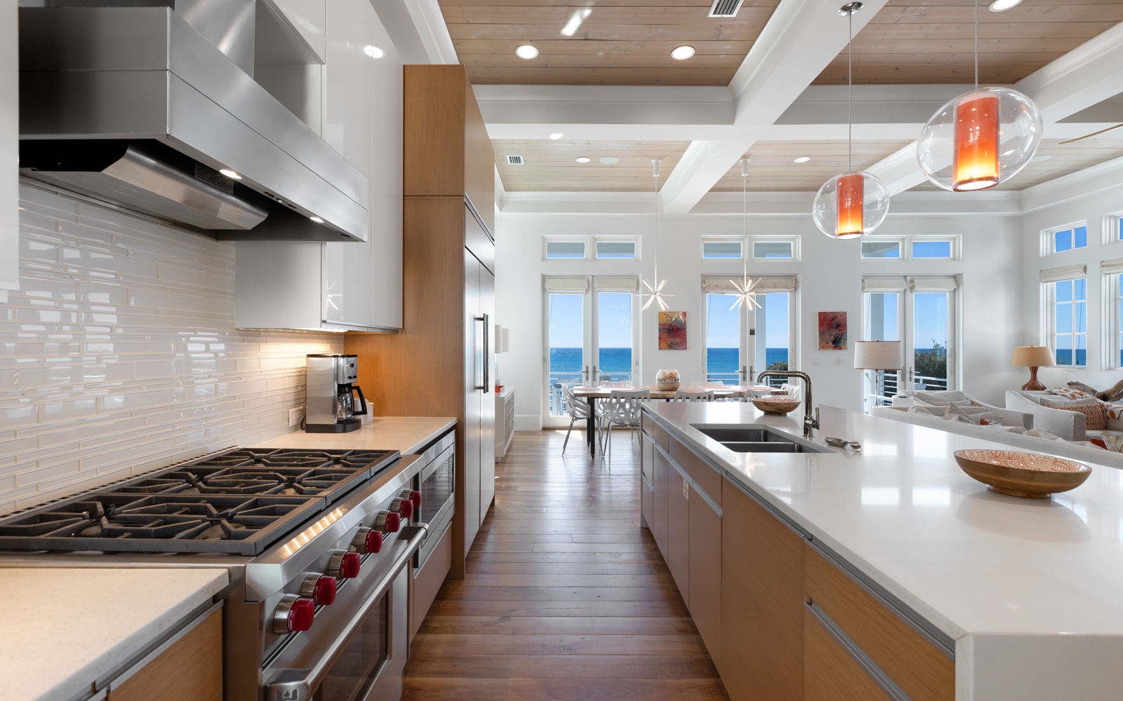 Your gourmet kitchen awaits with professional-grade appliances and stunning gulf views through floor-to-ceiling windows.