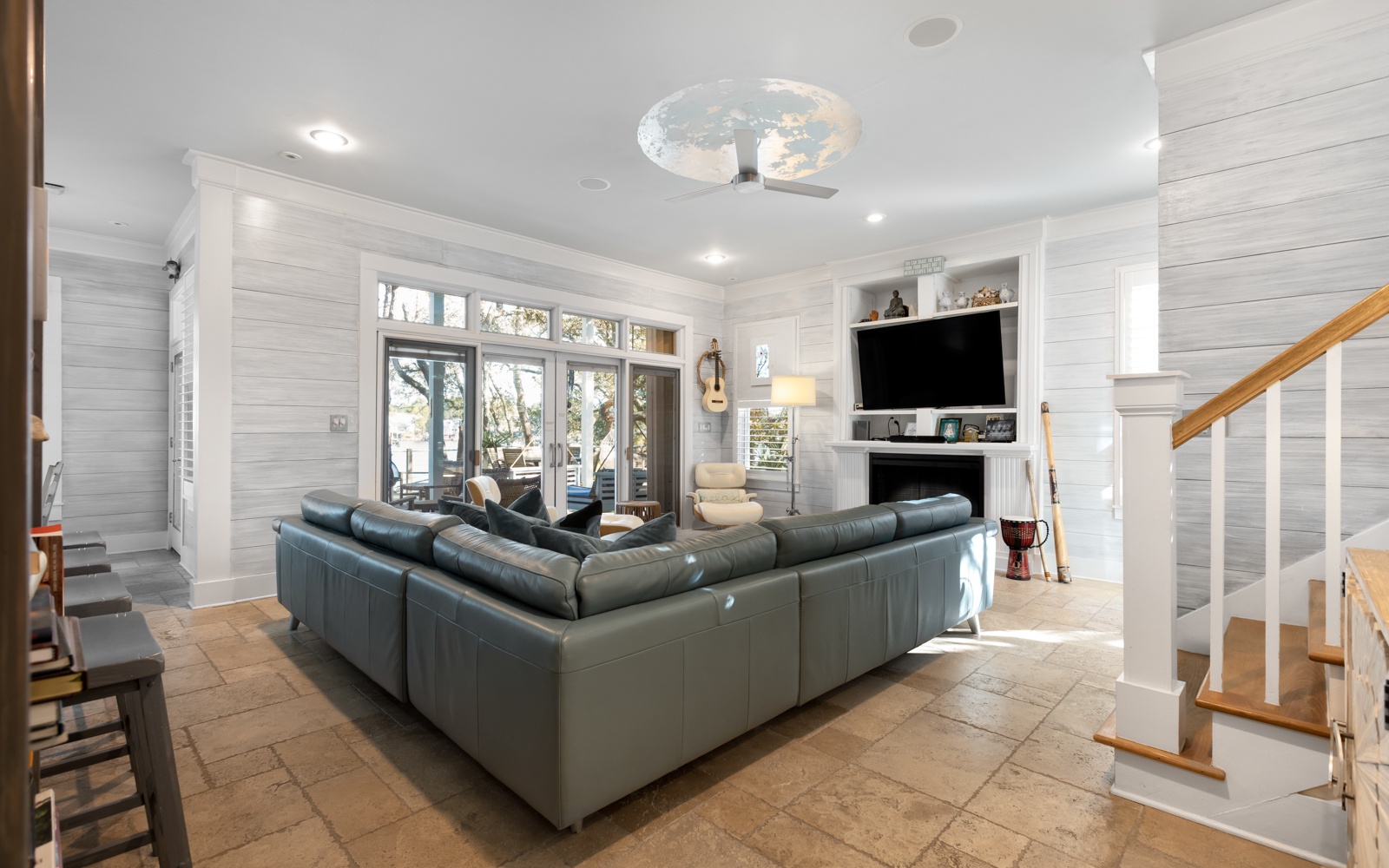 Unwind in your spacious living room with plush leather seating and cozy fireplace, perfect for relaxing after exploring.