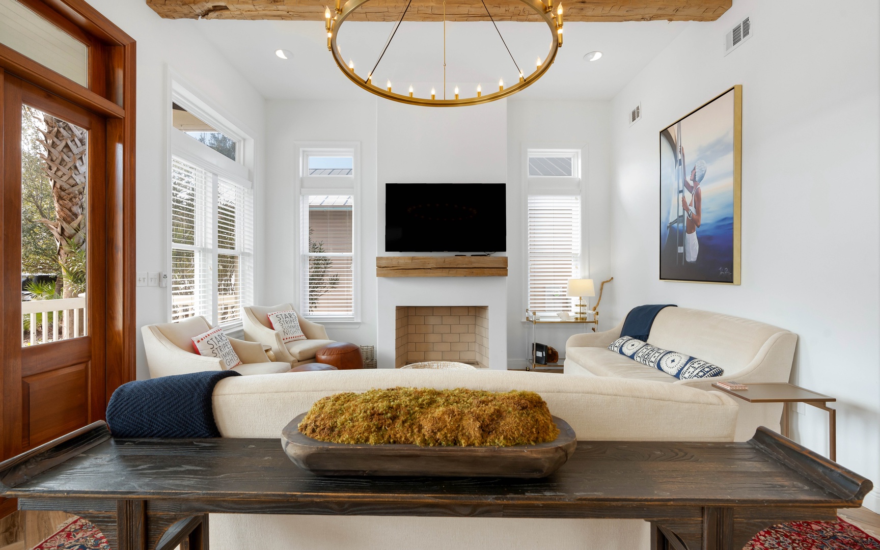 Unwind in your elegant living space with exposed beams, modern fireplace, and plush seating perfect for cozy evenings.