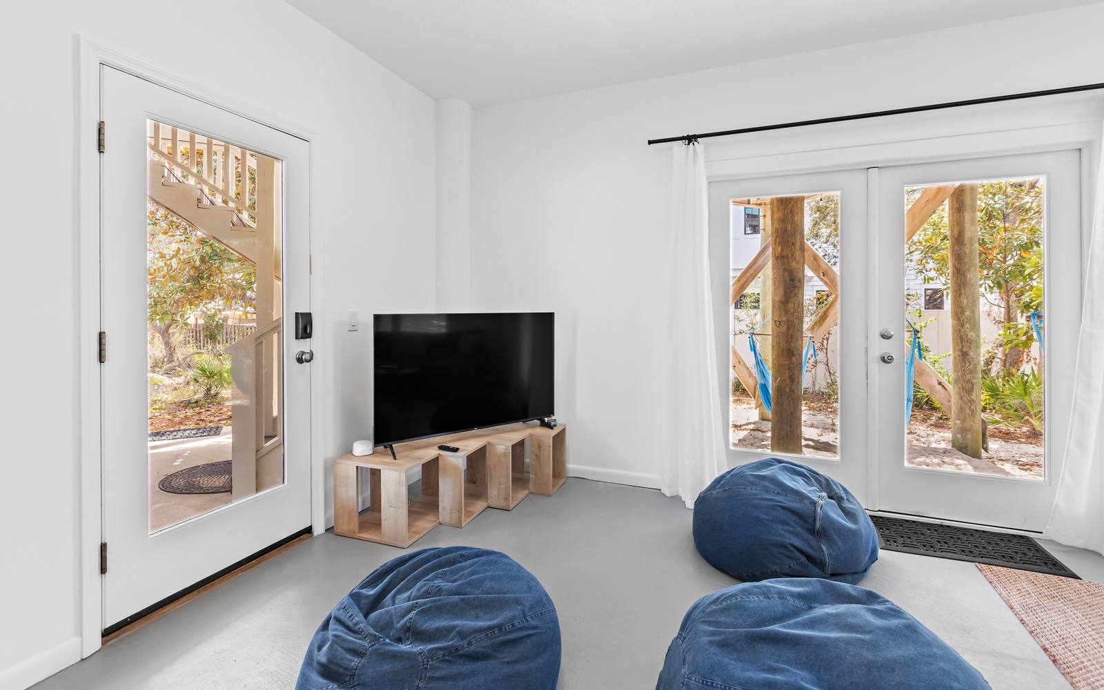 Sink into plush bean bags while you watch your favorite shows in this bright, modern living space with beautiful garden views.