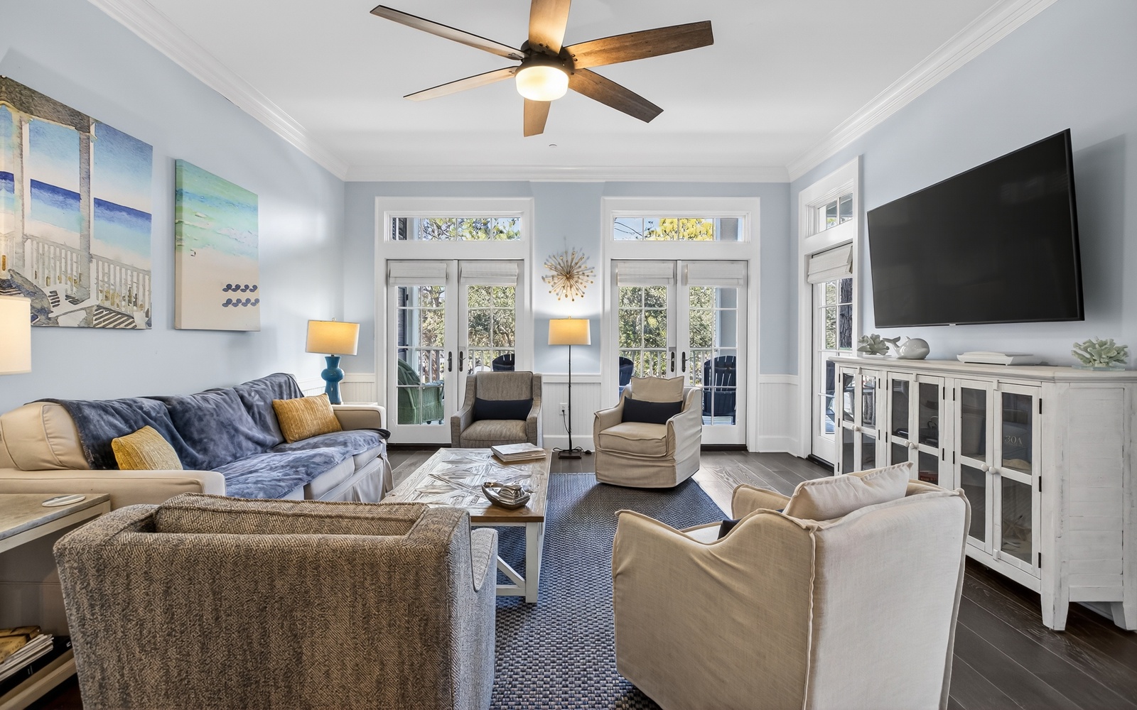 Settle into this bright, airy living room where coastal charm meets comfort. Plush seating and calming blues create your perfect relaxation retreat.