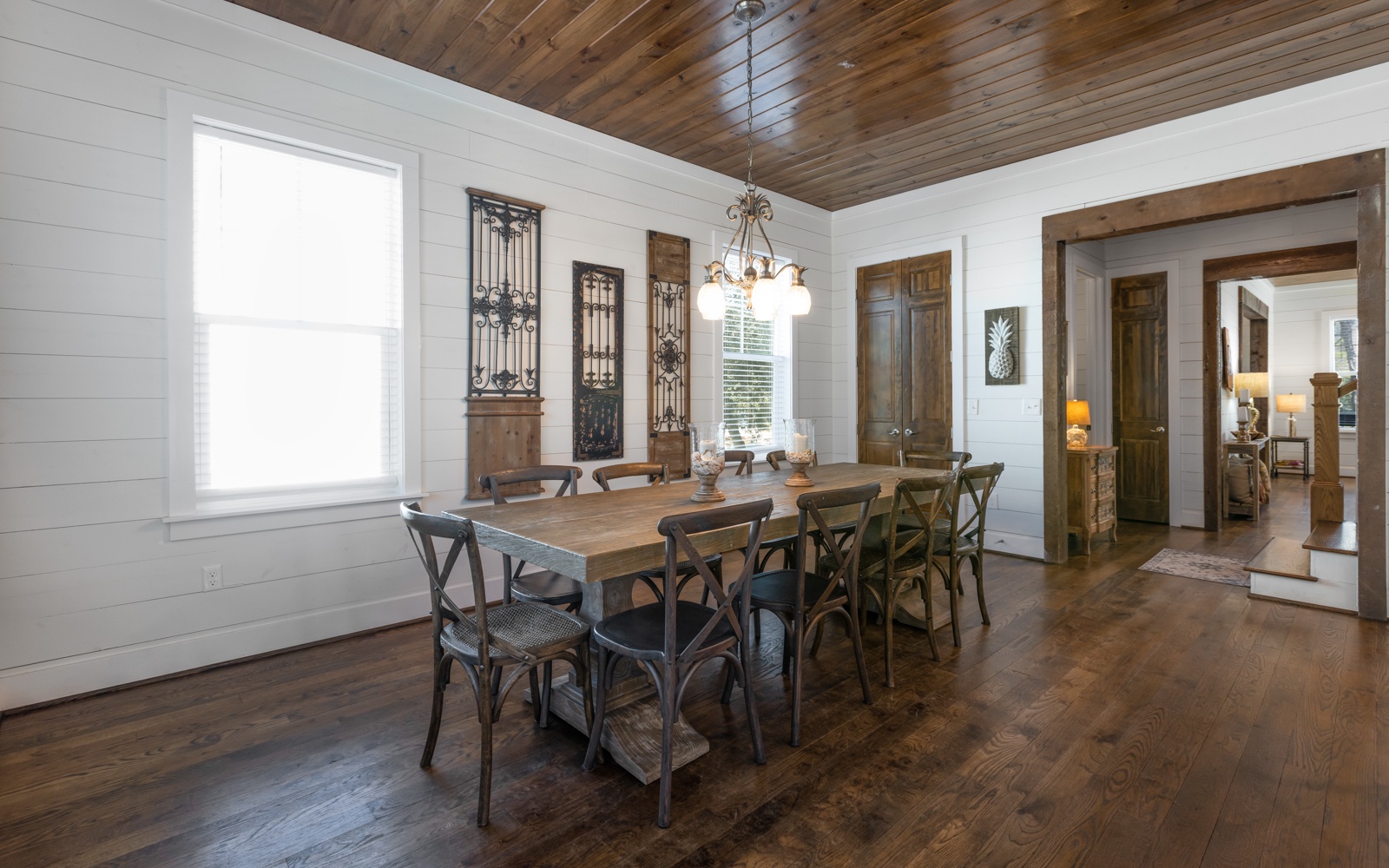 Gather around this stunning farmhouse dining table where warm wood meets elegant charm for memorable meals together.