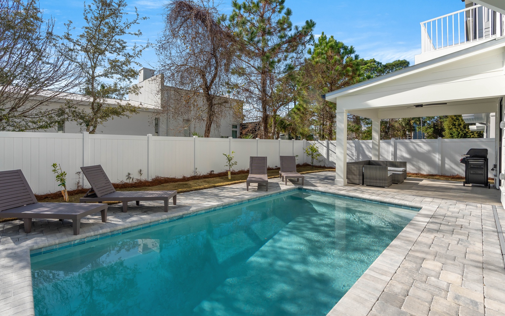 Dive into your private pool oasis, where sun loungers await and a covered patio provides shade for poolside dining.
