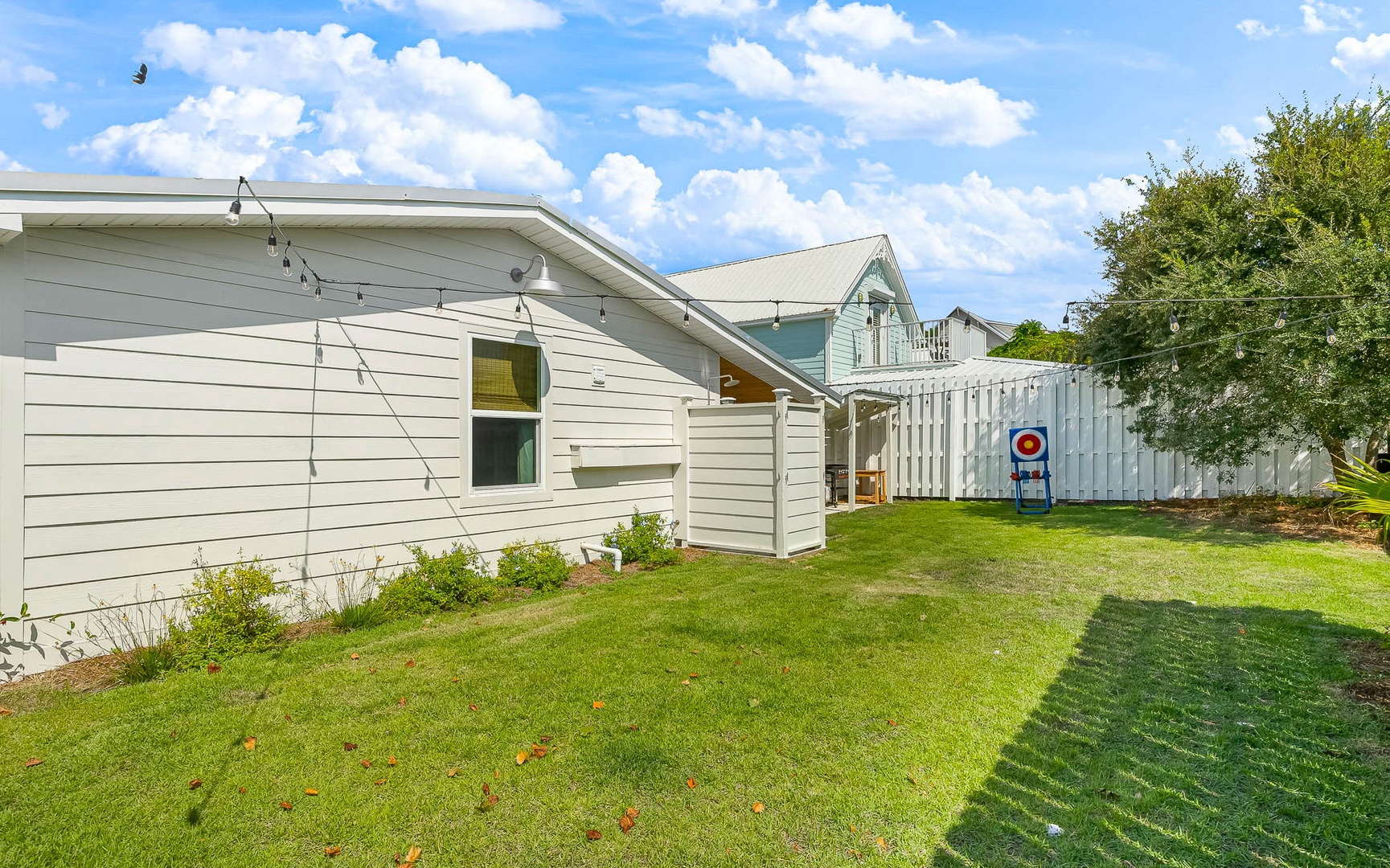 Charming white weatherboard property with spacious lawn and private fenced yard in peaceful residential setting.