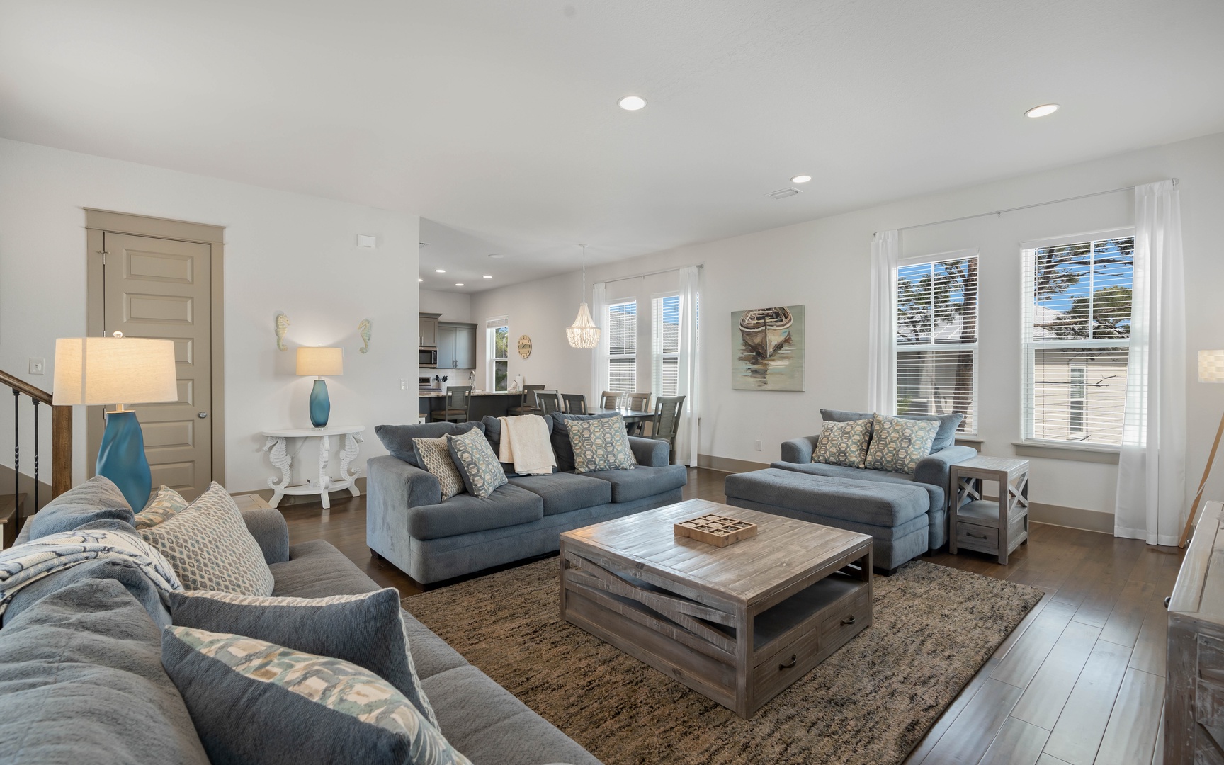 Sink into plush coastal comfort in this bright living space, where soft blue tones and natural textures create your perfect relaxation retreat.